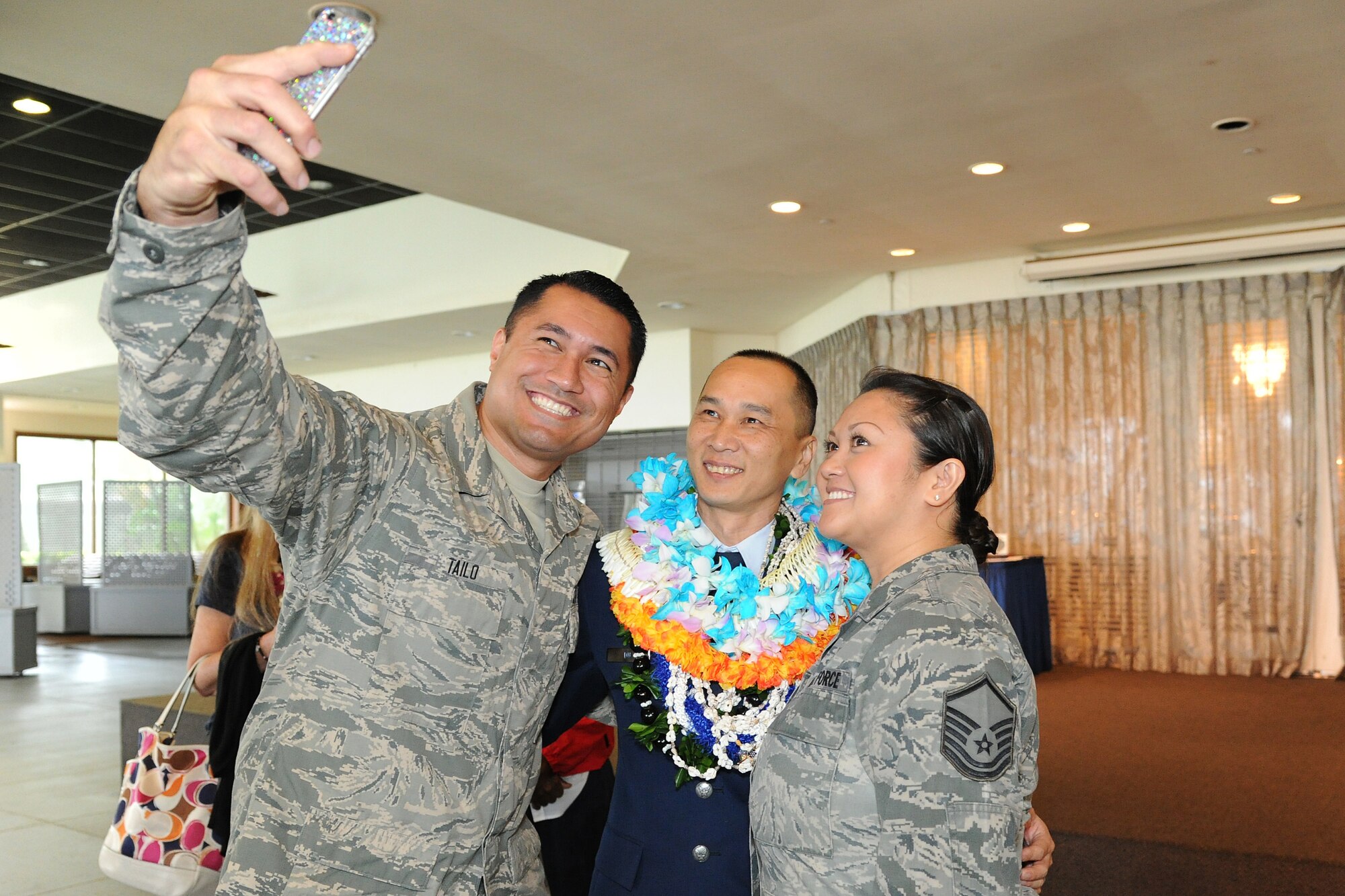 U.S. Air Force Senior Airmen BenTailo, left, and his wife Master Sgt. Maria Tailo take a selfie with Command Chief Master Sgt. Michael Du, of Walnut, Calif., after his retirement ceremony at the Historic Hickam Officers Club, Joint Base Pearl Harbor-Hickam, Hawaii, Feb. 11, 2017. Du spent more than two years as the senior enlisted leader for the 624th Regional Support Group. Located on Oahu and Guam, and a component of the Air Force Reserve, the 624th Regional Support Group's mission is to deliver mission essential capability through combat readiness, quality management and peacetime deployments in the Pacific area of responsibility. (U.S. Air Force photo by Master Sgt. Theanne Herrmann)