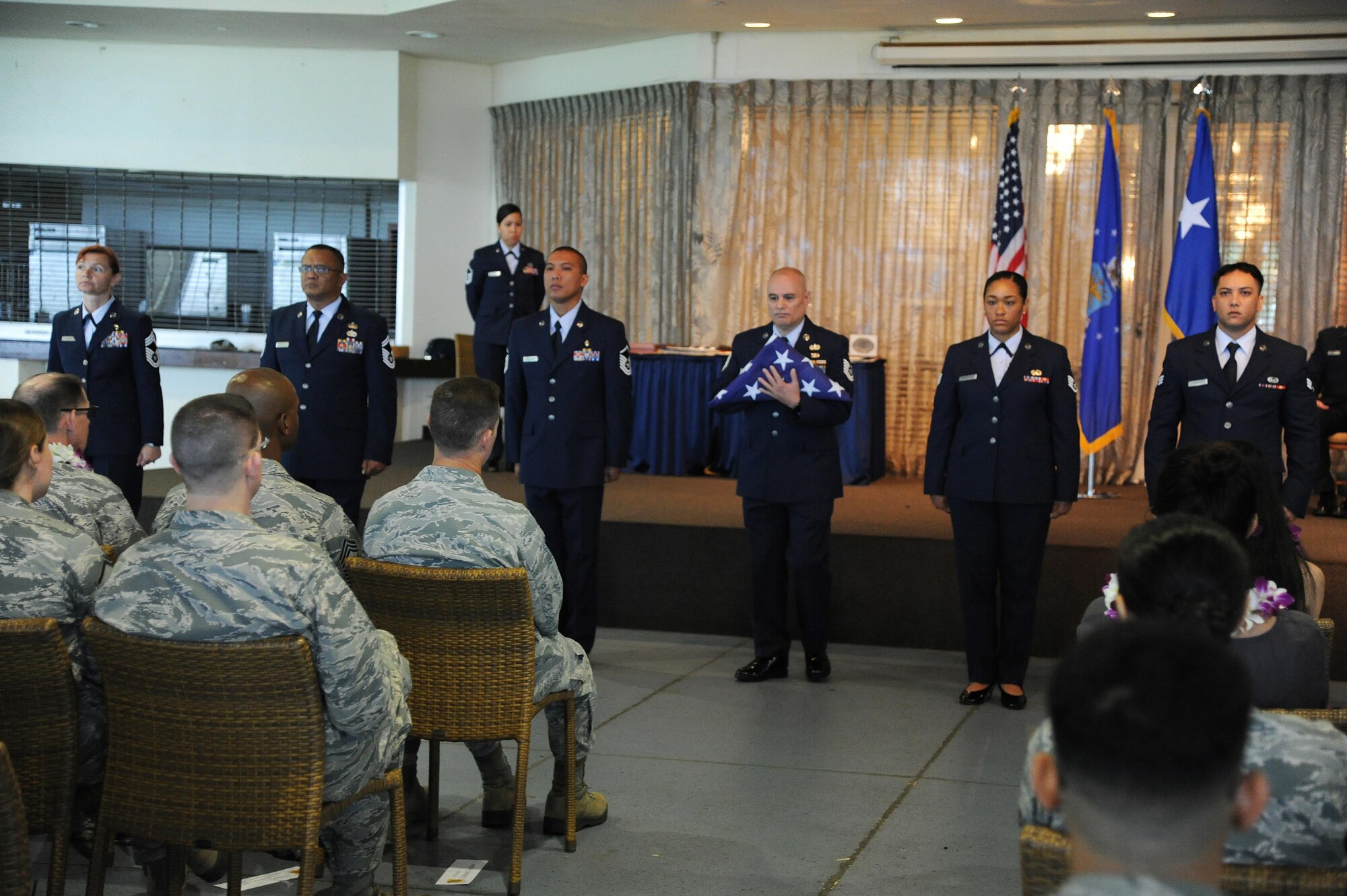 Members of the 624th Regional Support Group symbolically pass the American Flag through the enlisted ranks commemorating the career of Command Chief Master Sgt. Michael Du, of Walnut, Calif., during his retirement ceremony at the Historic Hickam Officers Club, Joint Base Pearl Harbor-Hickam, Hawaii, Feb. 11, 2017. Du culminated his career as the senior enlisted leader for the 624th Regional Support Group. Located on Oahu and Guam, and a component of the Air Force Reserve, the 624th Regional Support Group's mission is to deliver mission essential capability through combat readiness, quality management and peacetime deployments in the Pacific area of responsibility. (U.S. Air Force photo by Master Sgt. Theanne Herrmann)