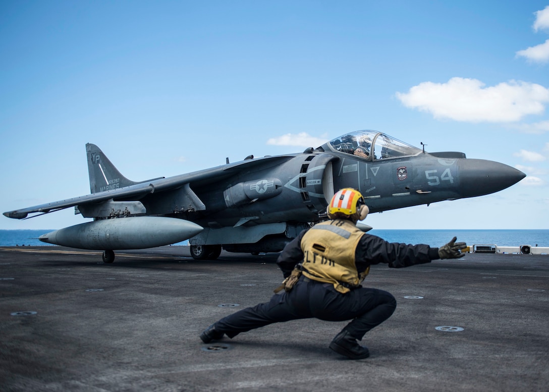 U.S. 5TH FLEET AREA OF OPERATIONS (Feb. 10, 2017) Aviation Boatswain’s Mate (Handling) 2nd Class Morgan Jackson, from Los Angeles, signals to an AV-8B Harrier, assigned to the Ridge Runners of Marine Medium Tiltrotor Squadron (VMM) 163, to launch aboard the amphibious assault ship USS Makin Island (LHD 8). Makin Island is deployed in the U.S. 5th Fleet area of operations in support of maritime security operations designed to reassure allies and partners, and preserve the freedom of navigation and the free flow of commerce in the region.  (U.S. Navy photo by Mass Communication Specialist 3rd Class Devin M. Langer/released)