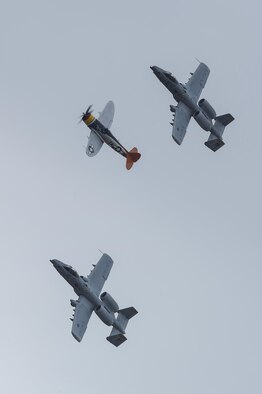 Two U.S. Air Force A-10C Thunderbolt IIs and a P-47 Thunderbolt fly together during the 2017 Heritage Flight Training and Certification Course at Davis-Monthan Air Force Base, Ariz., Feb. 12, 2017. The HFTCC provides civilian and military pilots the opportunity to practice flying in formation together in preparation for future air shows. (U.S. Air Force photo by Senior Airman Chris Drzazgowski)