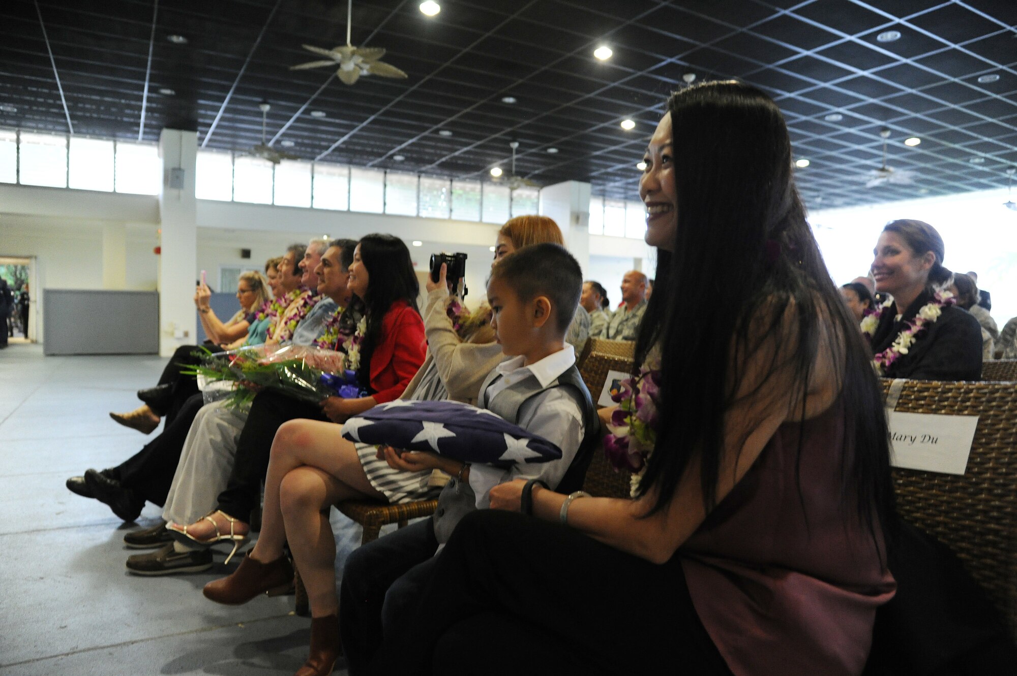 Mary Du, of Walnut, Calif., proudly holds an American Flag presented to her family during her husbands, Command Chief Master Sgt. Michael Du, retirement ceremony at the Historic Hickam Officers Club, Joint Base Pearl Harbor-Hickam, Hawaii, Feb. 11, 2017. Du has spent more than two years as the Command Chief for the 624th Regional Support Group and is retiring with more than 25 years of service. Located on Oahu and Guam, and a component of the Air Force Reserve, the 624th Regional Support Group's mission is to deliver mission essential capability through combat readiness, quality management and peacetime deployments in the Pacific area of responsibility. (U.S. Air Force photo by Master Sgt. Theanne Herrmann)