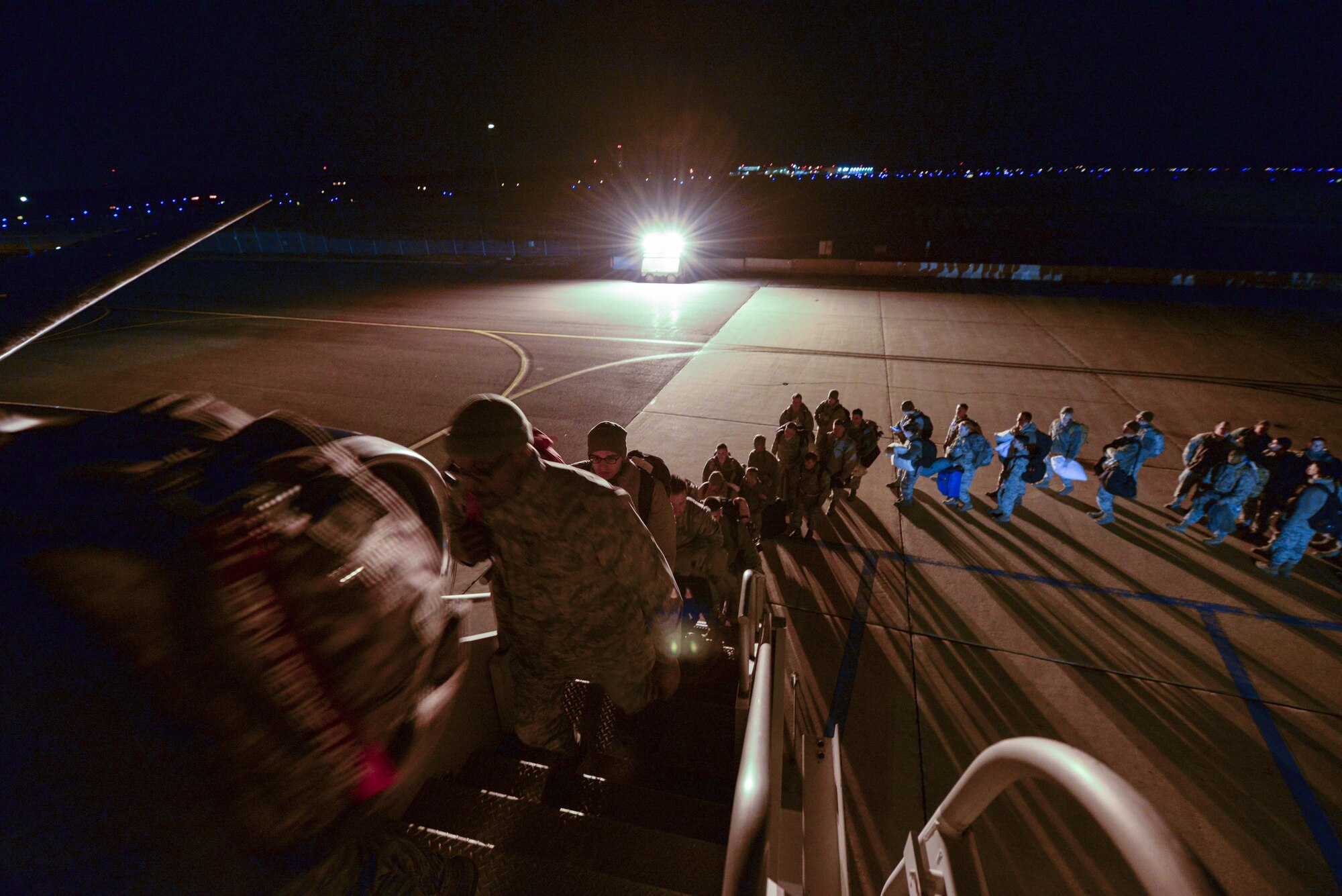 A picture of U.S. Air Force Airmen from the New Jersey Air National Guard's 177th Fighter Wing boarding a commercial aircraft.