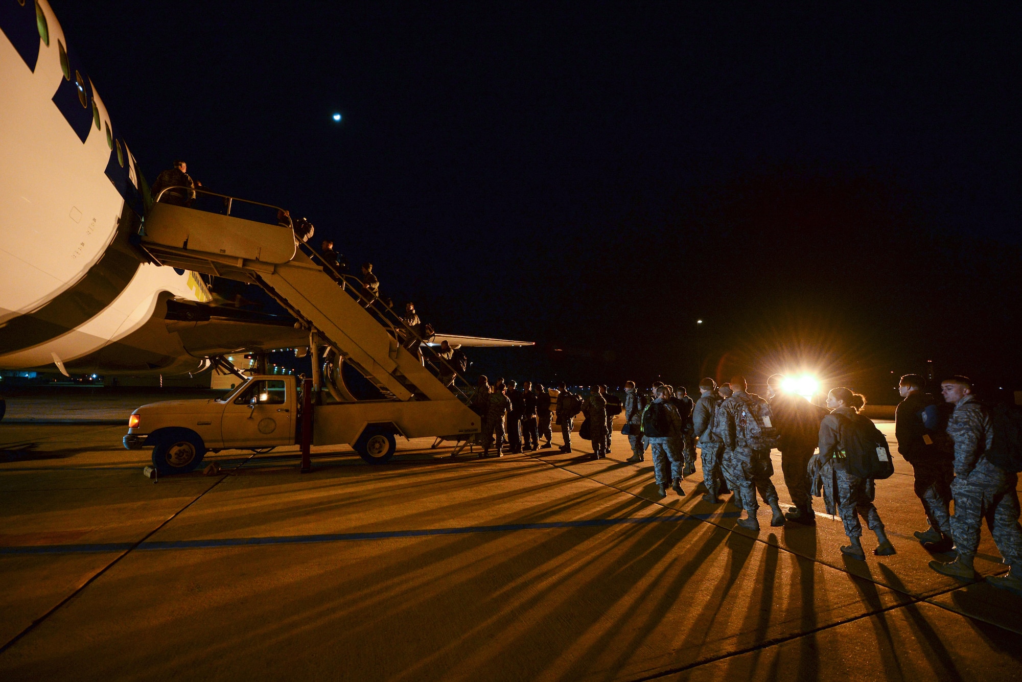 A picture of U.S. Air Force Airmen from the New Jersey Air National Guard's 177th Fighter Wing boarding a commercial aircraft.