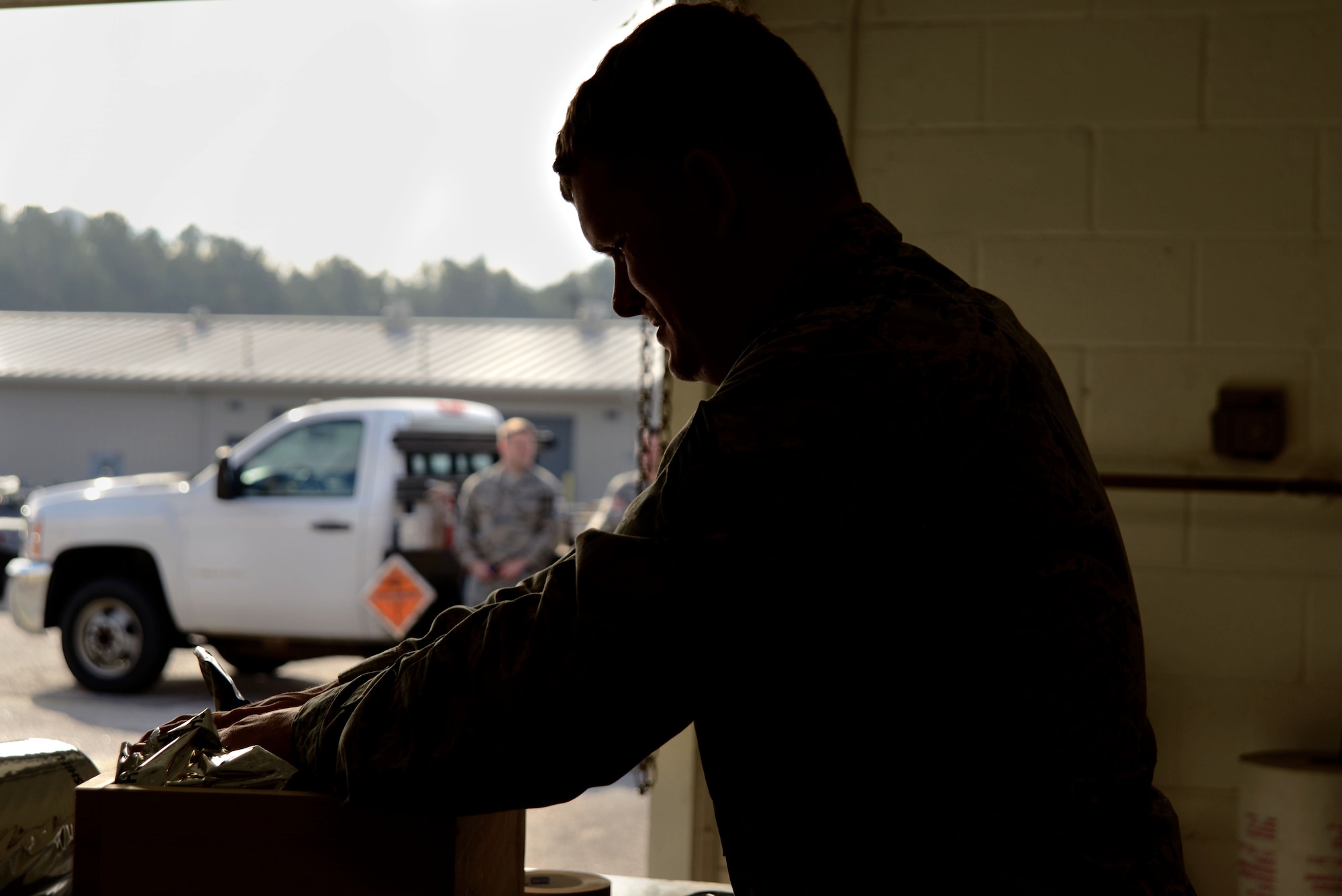 U.S. Air Force Staff Sgt. Cameron Miller, 20th Equipment Maintenance Squadron munitions inspector, packs a box of 40 mm grenades into a crate at Shaw Air Force Base, S.C., Feb. 6, 2017. The crate protects the box of munitions during storage and transportation. (U.S. Air Force photo by Airman 1st Class Kathryn R.C. Reaves)