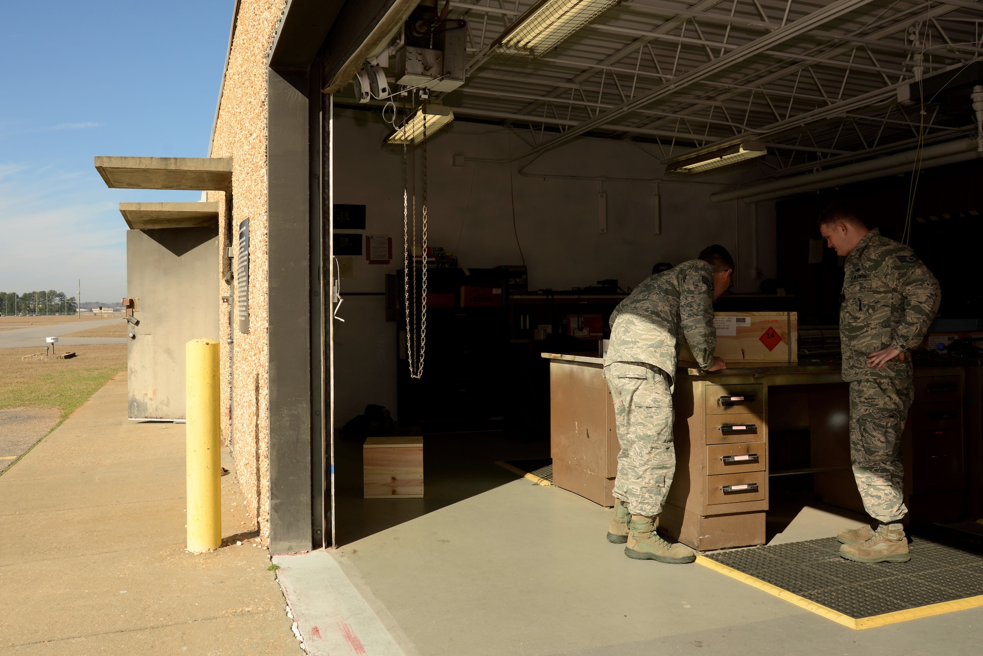 U.S. Air Force Staff Sgt. Ralph Simons, left, and Staff Sgt. Cameron Miller, right, 20th Equipment Maintenance Squadron munitions inspectors, review a crate of munitions at Shaw Air Force Base, S.C., Feb. 6, 2017. The outside of the crate indicates factors such as the munition’s type, count, national stock number and hazard class. (U.S. Air Force photo by Airman 1st Class Kathryn R.C. Reaves)
