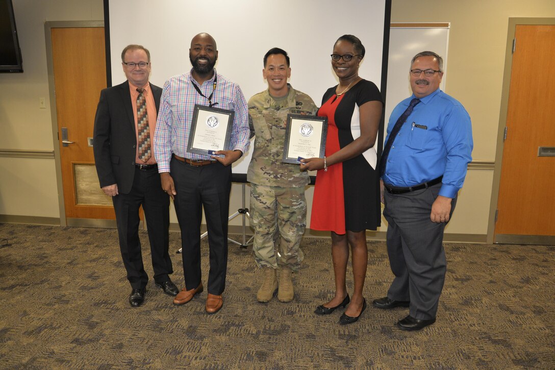 Brig. Gen. Toy recognizes employees' federal service anniversaries with certificates of appreciation.