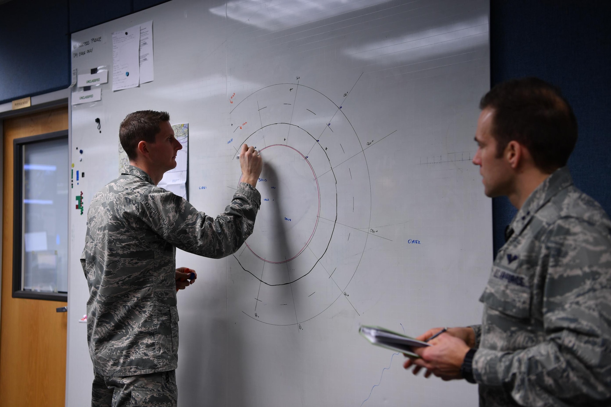 1st Lt. Krosby Keller (left), 225th Air Defense Squadron senior director, and Capt. John Dalrymple, 225th ADS mission planning cell chief, practice possible air defense intercept scenarios for Super Bowl LI.  The FAA placed a temporary 30-mile radius flight restricted area around NGR Stadium during the Super Bowl during which WADS was responisble for guarding the skies as part of NORAD's Operation Noble Eagle air defense mission. (U.S. Air Force photo by Kimberly D. Burke)