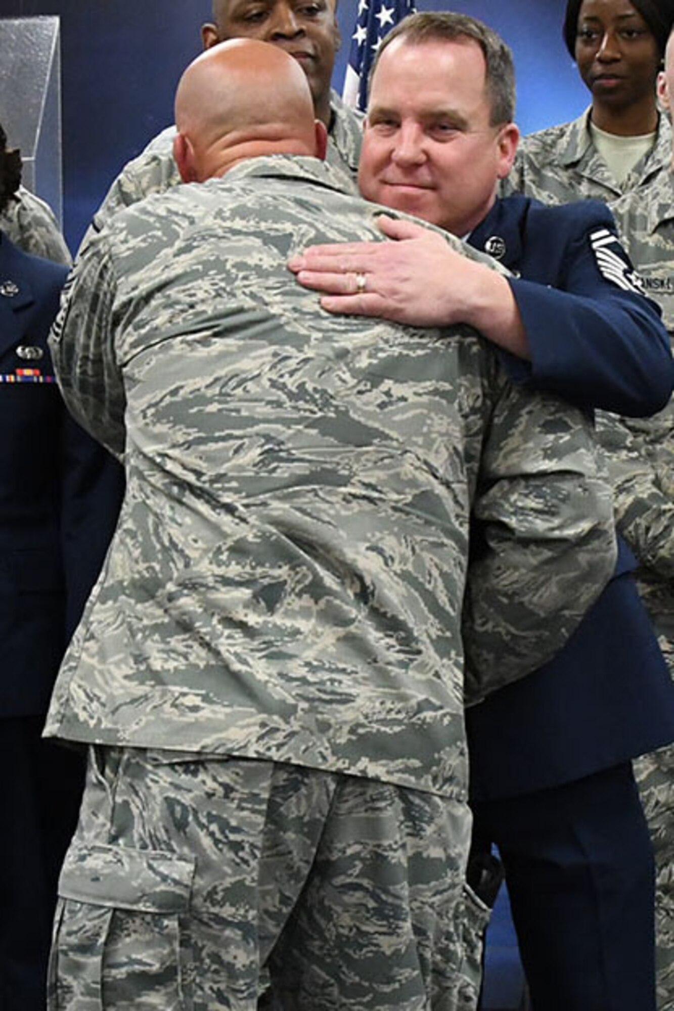 Retired U.S. Air Force Senior Master Sergeant Robert Ahbol, 307th Force Support Squadron communications flight superintendent hugs one of his Airman after his retirement ceremony at Barksdale Air Force Base, La., February 11, 2017.   Ahbol has been the unit’s communications flight superintendent since 2004.  His impact on technology in the Air Force goes all the way back to 1999, when he was still an Aerospace Ground Equipment mechanic.  In that year, he created a self-inspection database that was adopted service wide.   The effort helped his unit at the time, the 917th Wing, win the Air Force Chief of Staff Team Excellence Award. (U.S. Air Force photo by Staff Sgt. Callie Ware/Released)