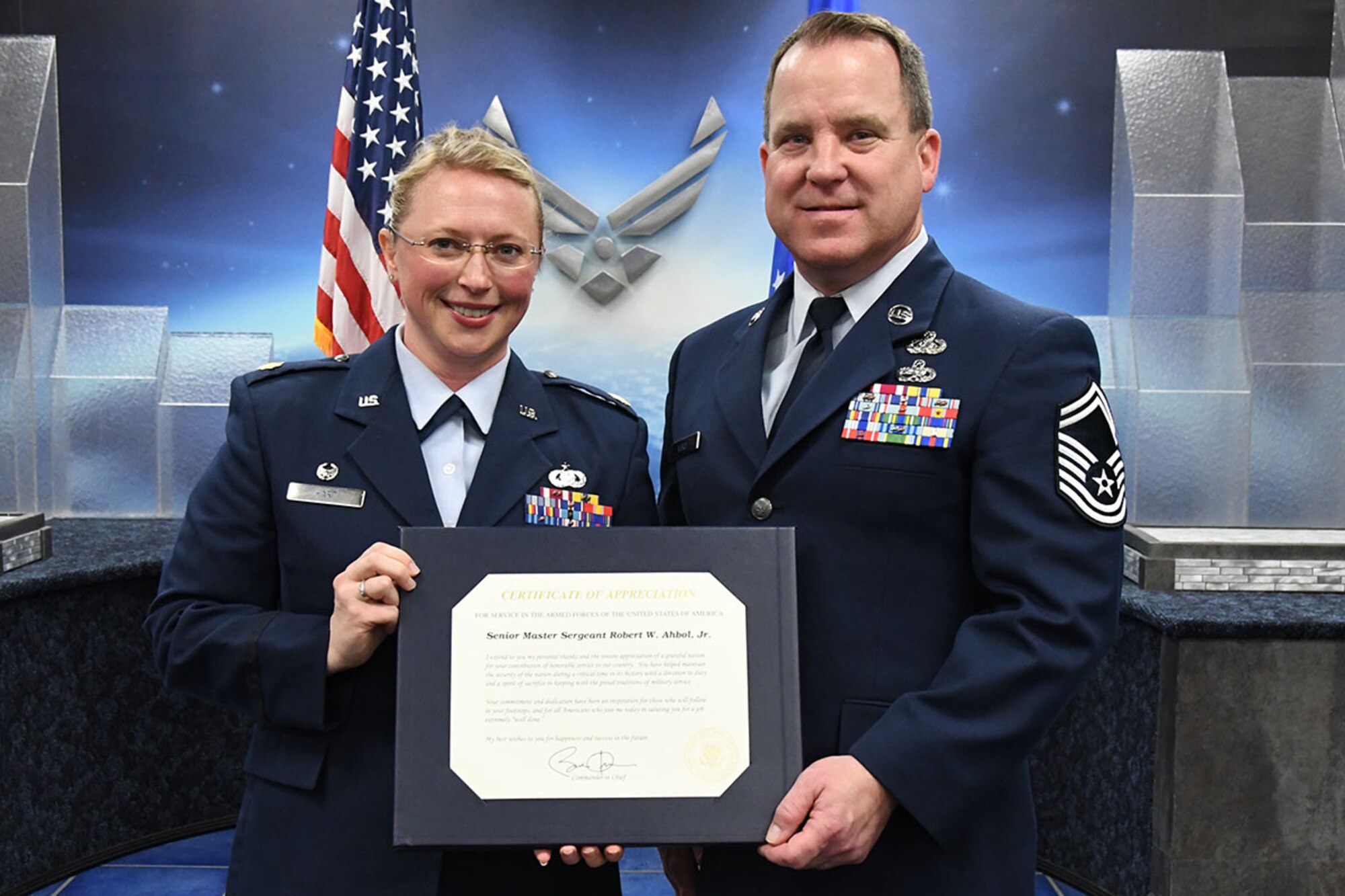 U.S. Air Force Major Beth Hart, the 307thForce Support Squadron Commander, presents Senior Master Sgt. Robert Ahbol, 307th Force Support Squadron communications flight superintendent, with a certificate of appreciation during his retirement ceremony at Barksdale Air Force Base, La., Feb. 11, 2017.  During his time as communications flight superintendent, Ahbol led teams responsible for numerous unit awards including the 2016 Capstone Superior Communications Team Award. (U.S. Air Force photo by Staff Sgt. Callie Ware/Released)