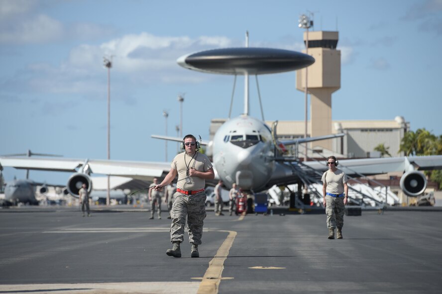 Senior Airman Alexander Sparks, an electrical and environmental specialist assigned to the 552nd Aircraft Maintenance Squadron, walks on the flight line on Jan. 25 at Joint Base Pearl Harbor-Hickam, Hawaii. Reservists and active-duty Airmen from the 513th Air Control Group and 552nd Air Control Wing deployed to the Hawaiian Islands to provide command and control for Sentry Aloha 17-01, a primarily Reserve and Air National Guard exercise that involves more than 40 aircraft and 1,000 personnel. (U.S. Air Force photo by 2nd Lt. Caleb Wanzer) (Parts of this image were blurred for security concerns.)