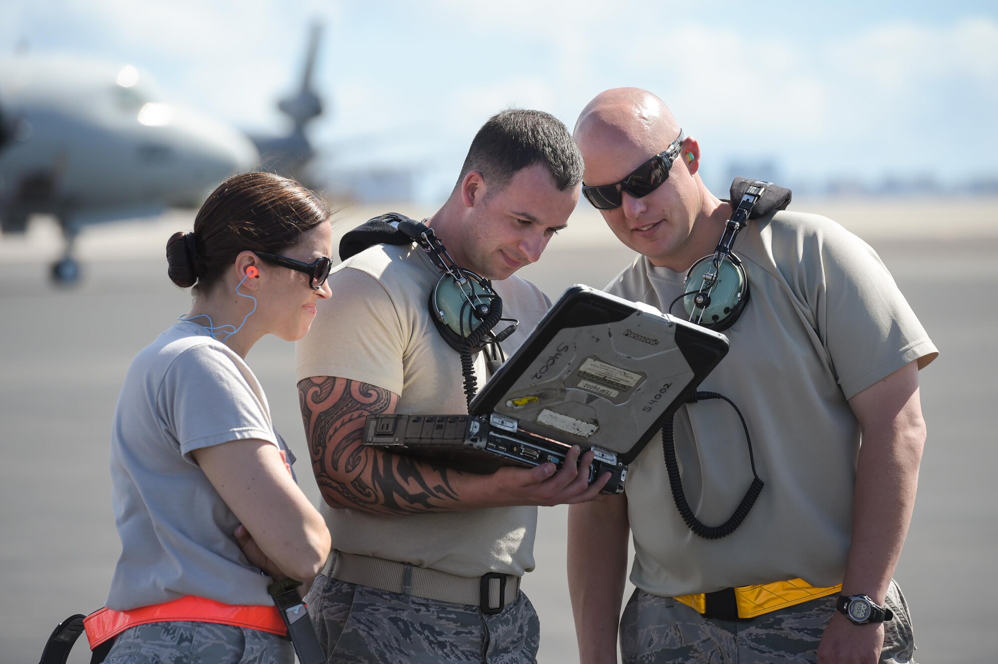 Master Sgt. Angela Leddy, Tech. Sgt. Andrew Mistowski and Master Sgt. Darrell Freel, Reservists assigned to the 513th Air Control Group, review a technical order on the flight line on Jan. 25 at Joint Base Pearl Harbor-Hickam, Hawaii. Reservists from the 513th Air Control Group deployed to the Hawaiian Islands to provide command and control for Sentry Aloha 17-01, a primarily Reserve and Air National Guard exercise that involves more than 40 aircraft and 1,000 personnel. (U.S. Air Force photo by 2nd Lt. Caleb Wanzer)