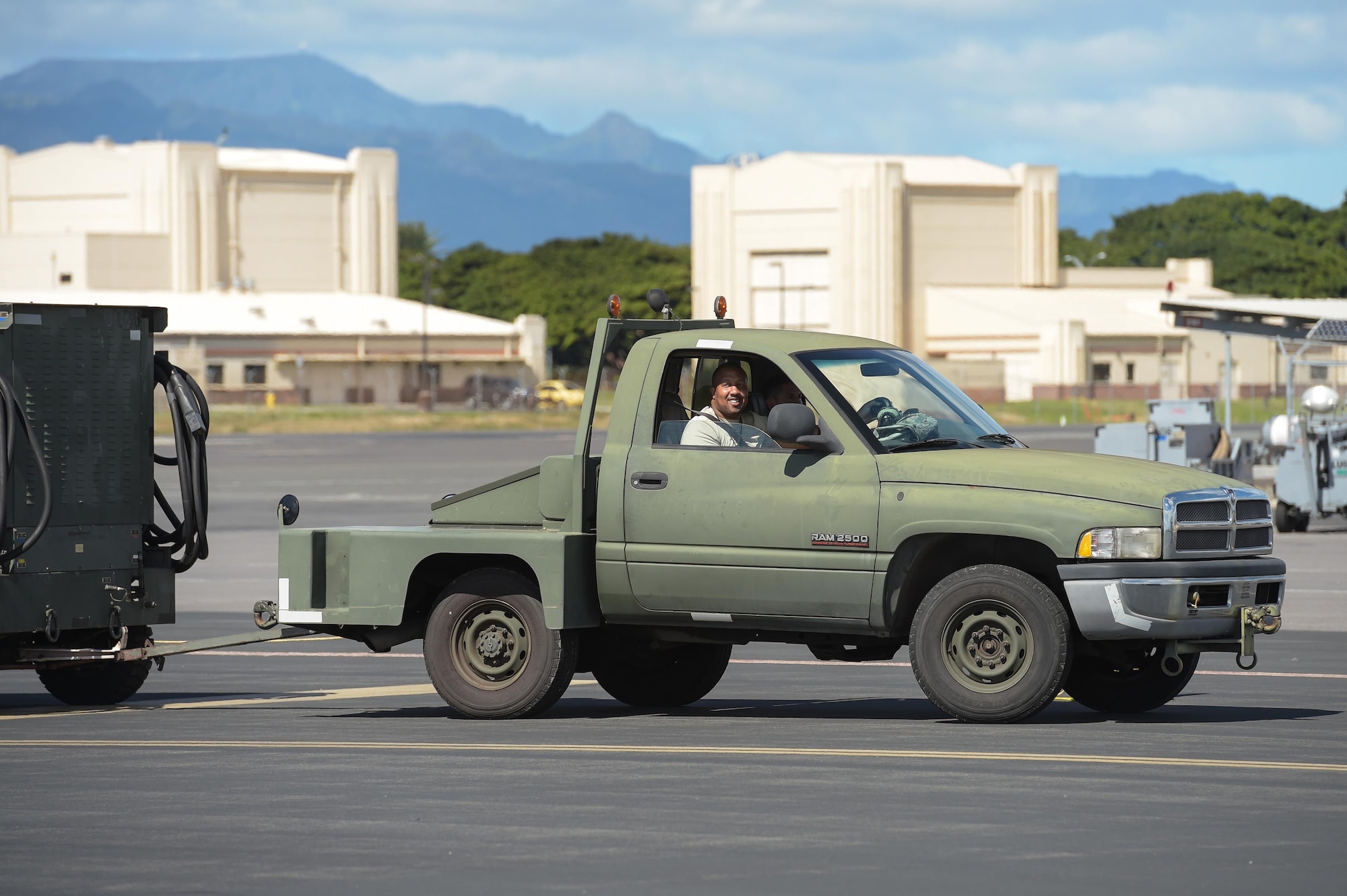Senior Master Sgt. Alphonzo Glover, an inspections superintendent for the 513th Air Control Group, rides in a bobtail Jan. 25 on the flight line at Joint Base Pearl Harbor-Hickam, Hawaii. Reservists from the 513th Air Control Group deployed to the Hawaiian Islands to provide command and control for Sentry Aloha 17-01, a primarily Reserve and Air National Guard exercise that involves more than 40 aircraft and 1,000 personnel. (U.S. Air Force photo by 2nd Lt. Caleb Wanzer)