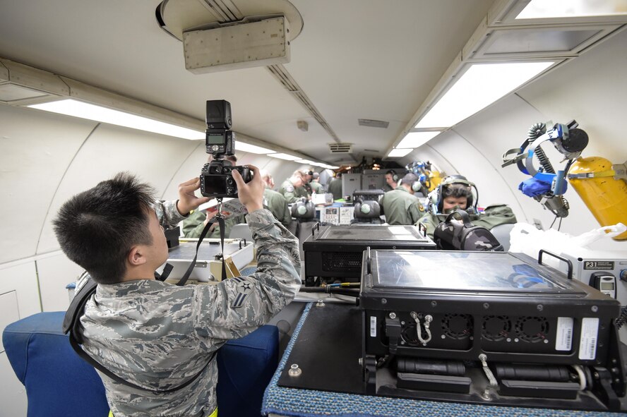 Airman 1st Class Stan Pak, a photojournalist assigned to the Hawaiian Air National Guard’s 154th Wing, takes a photo on board an E-3 Sentry Jan. 31 before a mission in support of Sentry Aloha at Joint Base Pearl Harbor-Hickam, Hawaii. Reservists from the 513th Air Control Group deployed to the Hawaiian Islands to provide command and control for Sentry Aloha 17-01, a primarily Reserve and Air National Guard exercise that involves more than 40 aircraft and 1,000 personnel. (U.S. Air Force photo by 2nd Lt. Caleb Wanzer)