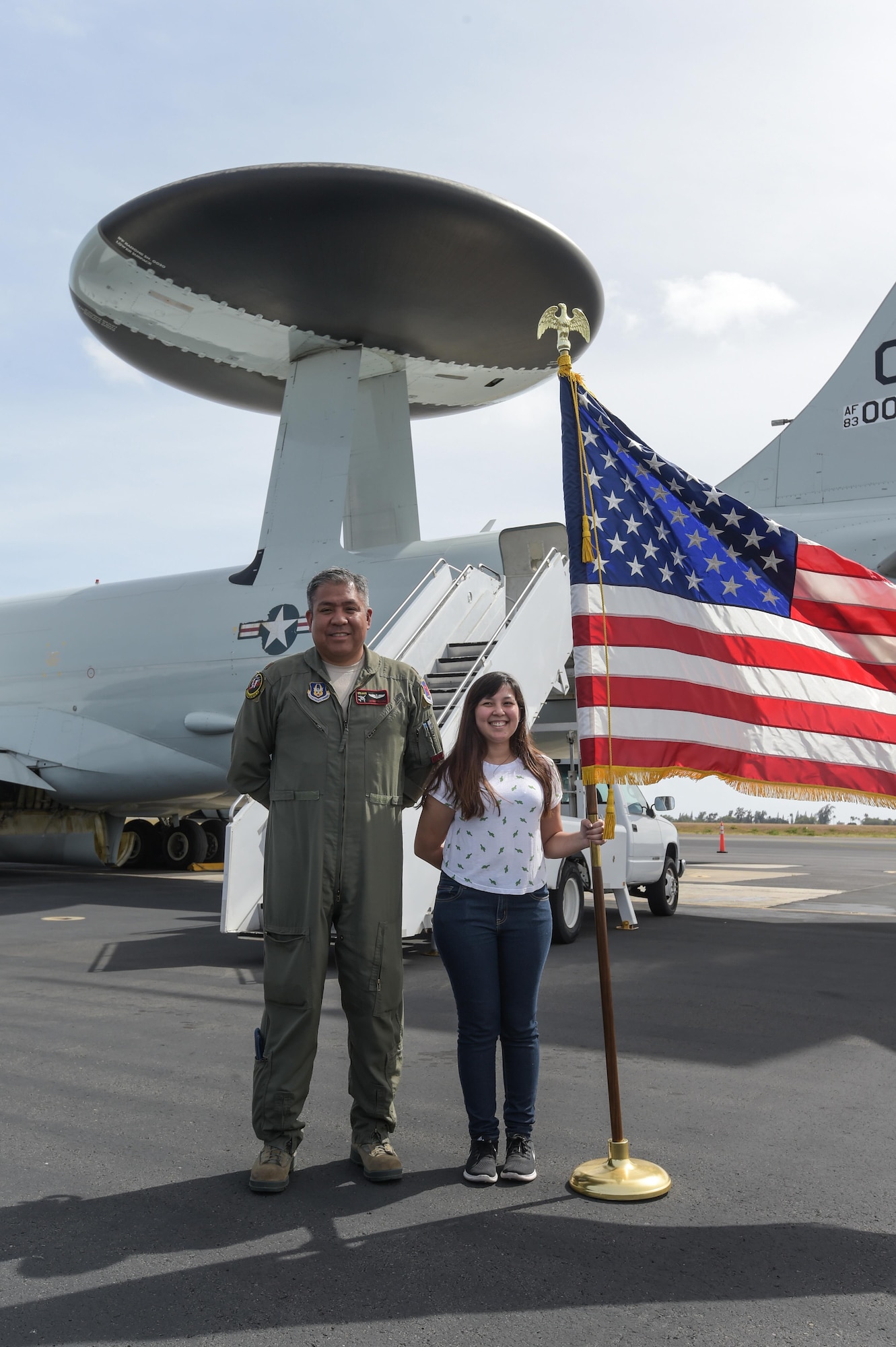 Maj. Johnny Villena, an air battle manager assigned to the 970th Airborne Air Control Squadron, poses with a brand-new member of the Hawaiian Air National Guard on Jan. 31 after completing her enlistment on board an E-3 Sentry Airborne Warning and Control System aircraft. Reservists from the 513th Air Control Group deployed to the Hawaiian Islands to provide command and control for Sentry Aloha 17-01, a primarily Reserve and Air National Guard exercise that involves more than 40 aircraft and 1,000 personnel. (U.S. Air Force photo by 2nd Lt. Caleb Wanzer)