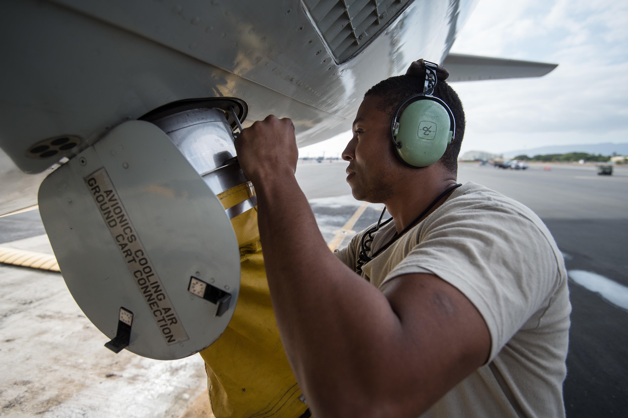 Senior Airman Najee Menefee, a communications and navigation specialist from the 513th Aircraft Maintenance Squadron, hooks up a forced air hose to an E-3 Sentry Airborne Warning and Control System aircraft on Feb. 4 at Joint Base Pearl Harbor-Hickam, Hawaii. Reservists from the 513th Air Control Group deployed to the Hawaiian Islands to provide command and control for Sentry Aloha 17-01, a primarily Reserve and Air National Guard exercise that involves more than 40 aircraft and 1,000 personnel. (U.S. Air Force photo by 2nd Lt. Caleb Wanzer)