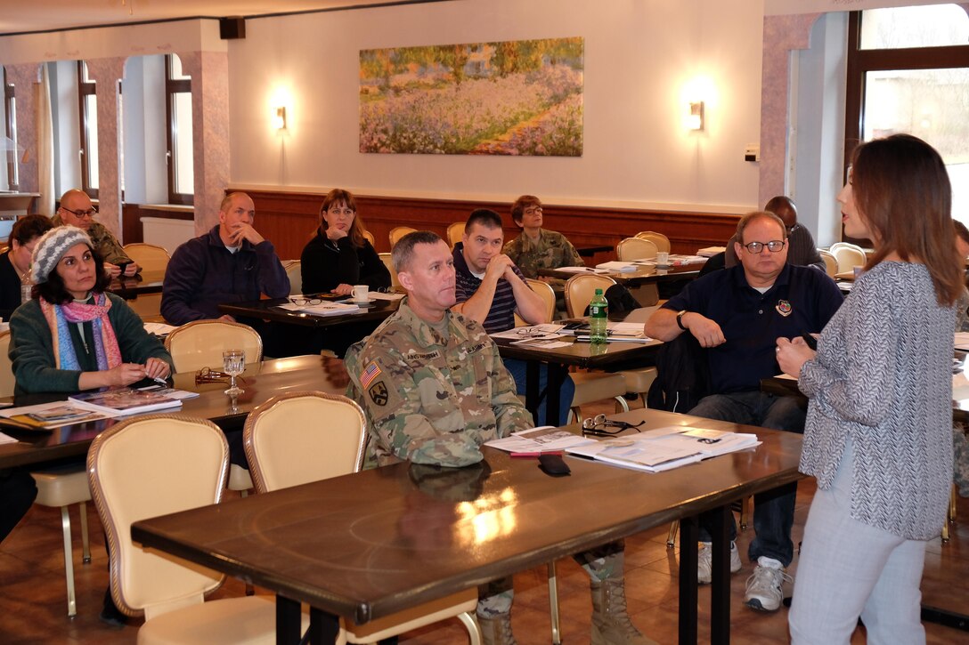 Brig. Gen. Steven W. Ainsworth, commanding general for the 7th Mission Support Command, center, listens to a brief on military retiree Tricare benefits during the 99th Regional Support Command Retirement Services Office bi-annual preretirement brief hosted by the 7th MSC, Feb. 4, 2017.