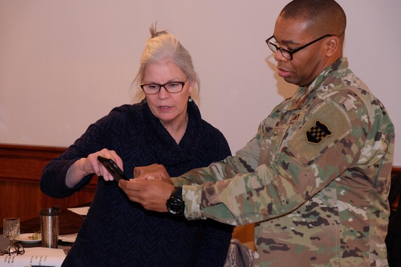 Master Sgt. Kevin Watts, noncommissioned officer in charge, Retirement Services Office, 99th Regional Support Command and an attendee of the 99th RSC RSO bi-annual preretirement brief hosted by the 7th MSC, Feb. 4, 2017 discuss the use of a smartphone to access more information.
