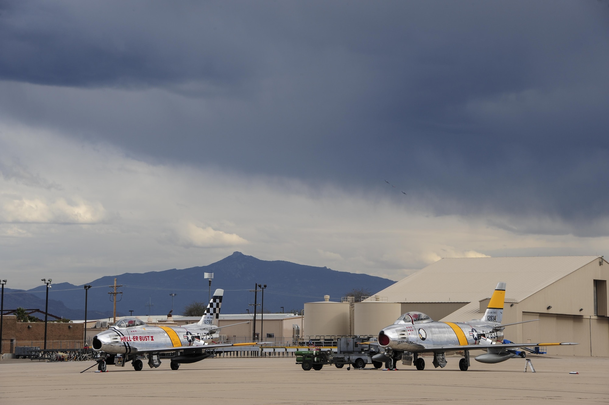 Two F-86 Sabres rest on the flight line during the 2017 Heritage Flight Training and Certification Course at Davis-Monthan Air Force Base, Ariz., Feb. 12, 2017. The annual aerial demonstration training event has been held at D-M since 2001. The modern aircraft that participated in this year's HFTCC were the F-35 Lightning II, the F-22 Raptor, F-16 Fighting Falcon and the A-10C Thunderbolt II. The historic aircraft included the P-51 and TF-51 Mustang, P-40 Warhawk, P-38 Lightning, P-47 Thunderbolt, T-33 Shooting Star and F-86 Sabre. (U.S. Air Force Photo by Airman 1st Class Nathan H. Barbour)