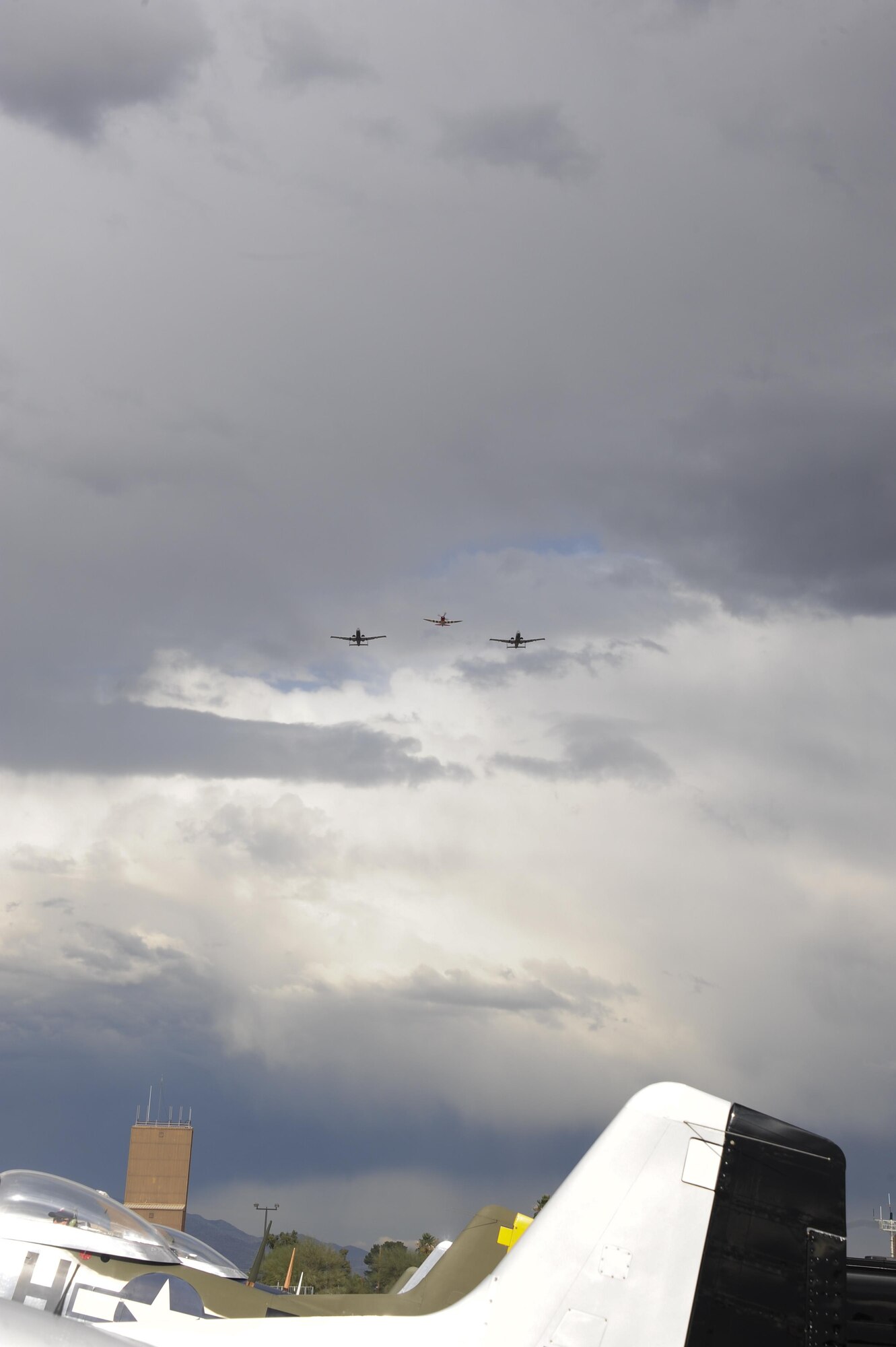 Two U.S. Air Force A-10C Thunderbolt IIs and a P-47 Thunderbolt fly in formation above historic aircraft during the 2017 Heritage Flight Training and Certification Course at Davis-Monthan Air Force Base, Ariz., Feb. 12, 2017. During the course, aircrews practiced ground and flight training to enable civilian pilots of historic military aircraft and U.S. Air Force pilots of current fighter aircraft to safely fly in formations together. (U.S. Air Force Photo by Airman 1st Class Nathan H. Barbour)