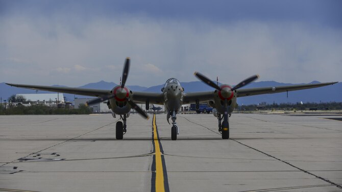 A P-38 lightning taxies on the flight line during the 2017 Heritage Flight Training and Certification Course at Davis-Monthan Air Force Base, Ariz., Feb. 12, 2017. The HFTCC provides civilian and military pilots the opportunity to practice flying in formation together in preparation for future air shows. (U.S. Air Force Photo by Airman 1st Class Nathan H. Barbour)