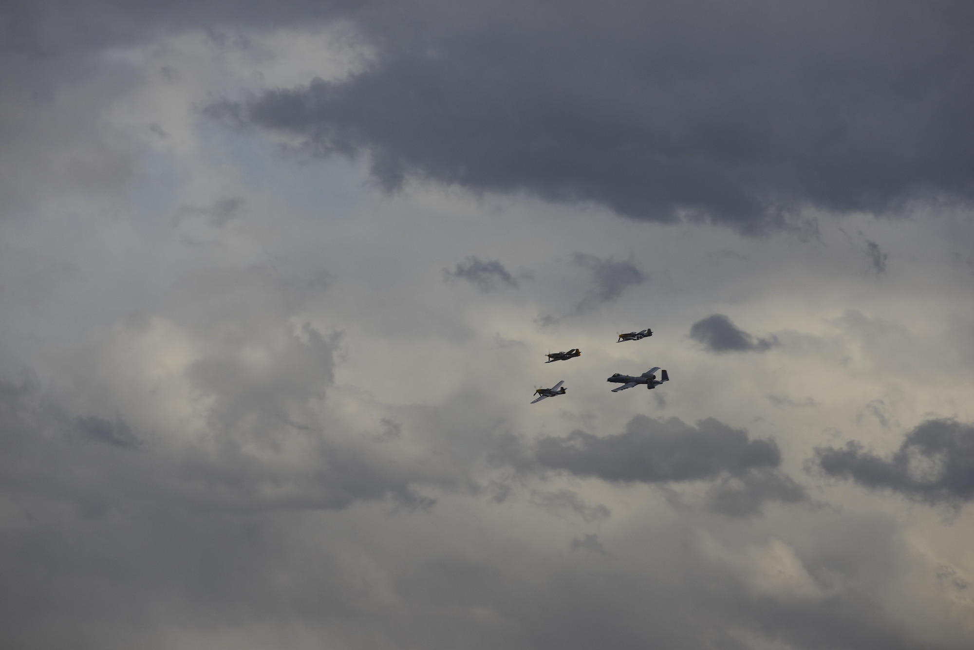 A U.S. Air Force A-10C Thunderbolt II, a TF-51 and two P-51 Mustangs fly in formation during the 2017 Heritage Flight Training and Certification Course at Davis-Monthan Air Force Base, Ariz., Feb. 12, 2017. The annual aerial demonstration training event has been held at D-M since 2001 and features aerial demonstrations from historical and modern fighter aircraft. (U.S. Air Force Photo by Airman 1st Class Nathan H. Barbour)