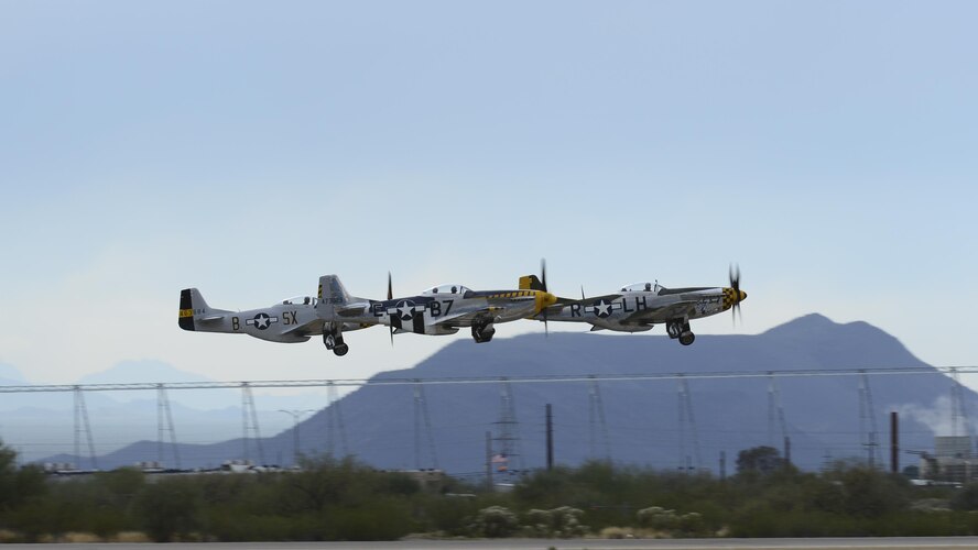 A TF-51 and two P-51 Mustangs take off during the 2017 Heritage Flight Training and Certification Course at Davis-Monthan Air Force Base, Ariz., Feb. 12, 2017. During the course, aircrews practice ground and flight training to enable civilian pilots of historic military aircraft and U.S. Air Force pilots of current fighter aircraft to safely fly in formations together. (U.S. Air Force Photo by Airman 1st Class Nathan H. Barbour)