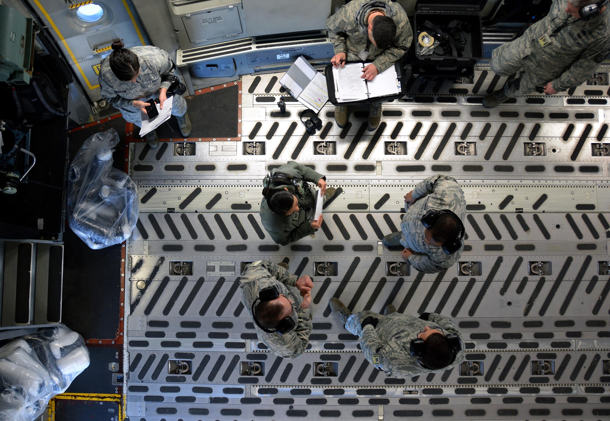 Citizen Airmen from the 945th Aircraft Maintenance Squadron go over their inspection notes for a C-17 Globemaster III prior to its take off from Travis Air Force Base, Calif., for Patriot Wyvern on Feb. 11, 2017. Patriot Wyvern is a hands-on, bi-annual event conducted by the 349th Air Mobility Wing designed to hone combat skills and improve organizational interoperability. (U.S. Air Force photo/Staff Sgt. Daniel Phelps)