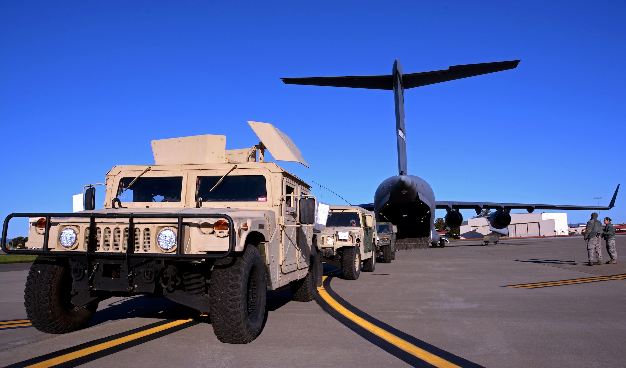Humvees line up before being backed into a C-17 Globemaster III prior to its take off from Travis Air Force Base, Calif., for Patriot Wyvern on Feb. 11, 2017. Patriot Wyvern is a hands-on, bi-annual event conducted by the 349th Air Mobility Wing designed to hone combat skills and improve organizational interoperability. (U.S. Air Force photo/Staff Sgt. Daniel Phelps)