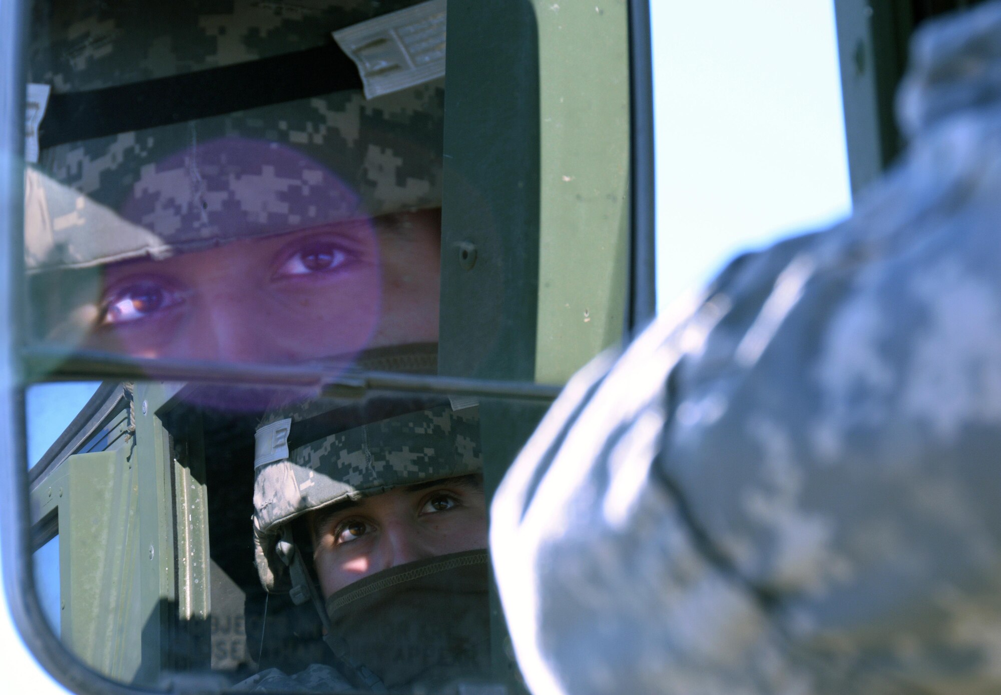 Specialist Michael Larriega, 801st Engineer Company horizontal engineer, awaits the go ahead for Humvees to be backed into a C-17 Globemaster III prior to its take off from Travis Air Force Base, Calif., for Patriot Wyvern on Feb. 11, 2017. Patriot Wyvern is a hands-on, bi-annual event conducted by the 349th Air Mobility Wing designed to hone combat skills and improve organizational interoperability. (U.S. Air Force photo/Staff Sgt. Daniel Phelps)