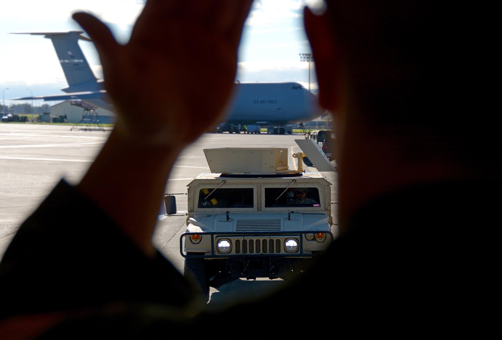 Air Force Staff Sgt. Devon Smith, 301st Airlift Squadron loadmaster, guides a Soldier from the 801st Engineer Company in a Humvee onto a C-17 Globemaster III prior to its take off from Travis Air Force Base, Calif., for Patriot Wyvern on Feb. 11, 2017. Patriot Wyvern is a hands-on, bi-annual event conducted by the 349th Air Mobility Wing designed to hone combat skills and improve organizational interoperability. (U.S. Air Force photo/Staff Sgt. Daniel Phelps)