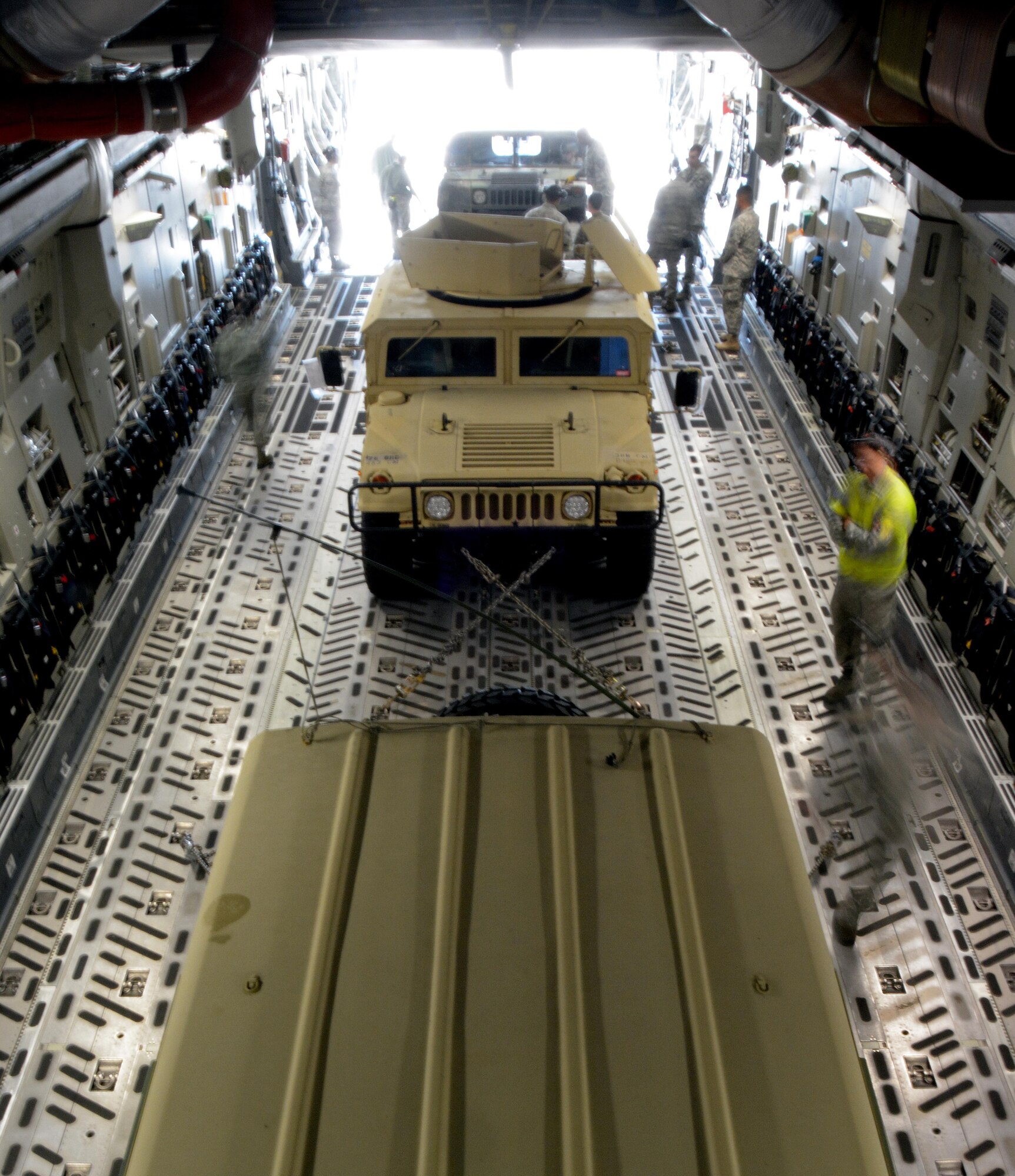 Citizen Airmen from the 349th Air Mobility Wing ensure Humvees are properly secured in a C-17 Globemaster III prior to its take off from Travis Air Force Base, Calif., for Patriot Wyvern on Feb. 11, 2017. Patriot Wyvern is a hands-on, bi-annual event conducted by the 349th Air Mobility Wing designed to hone combat skills and improve organizational interoperability. (U.S. Air Force photo/Staff Sgt. Daniel Phelps)