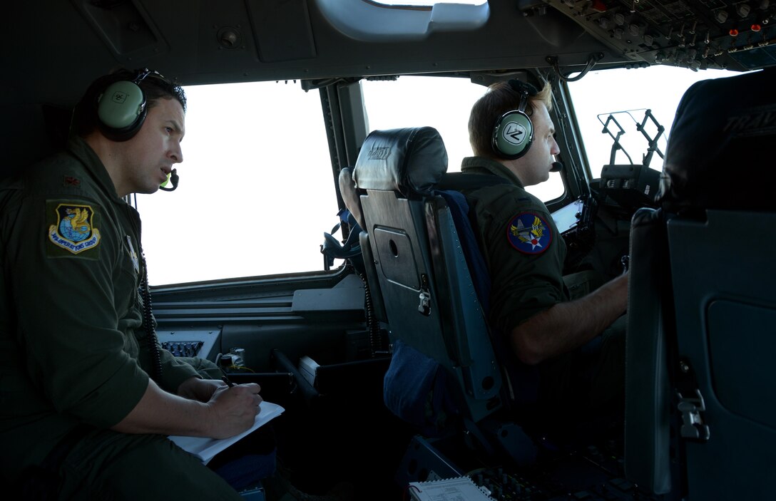 Maj. Clifton Tinkham, 301st Airlift Squadron C-17 Globemaster III pilot, takes notes during a flight during Patriot Wyvern on Feb. 11, 2017. Patriot Wyvern is a hands-on, bi-annual event conducted by the 349th Air Mobility Wing designed to hone combat skills and improve organizational interoperability. (U.S. Air Force photo/Staff Sgt. Daniel Phelps)
