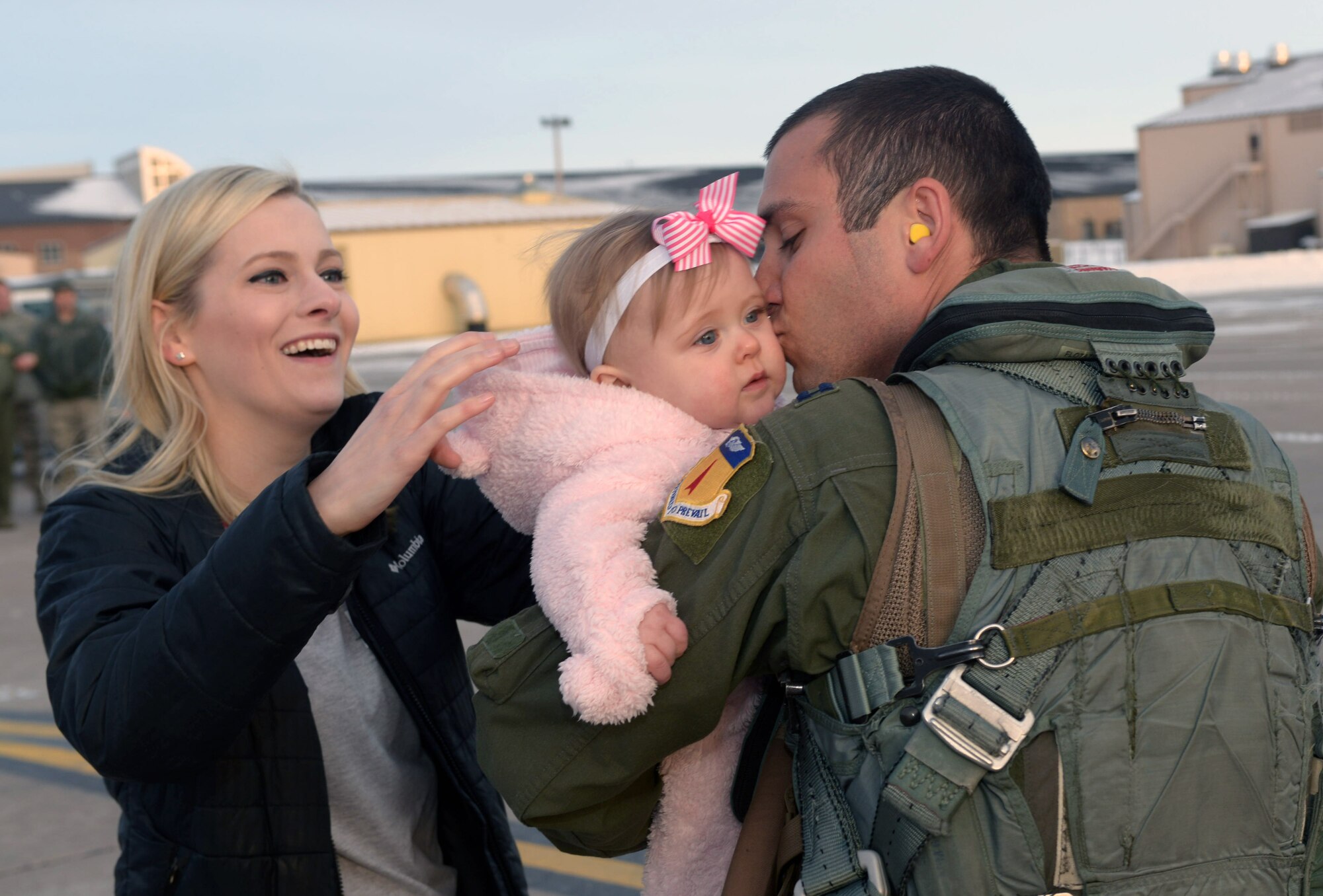 Capt. Alex, a pilot assigned to the 34th Expeditionary Bomb Squadron, reunites with his wife, Becky, and his daughter, Grace, at Ellsworth Air Force Base, S.D., Feb. 8, 2017, after his deployment to Guam, in support of the U.S. Pacific Command’s Continuous Bomber Presence mission. Members of the 34th EBS flew a total of 242 sorties during the deployment. (U.S. Air Force photo by Airman 1st Class Donald C. Knechtel)