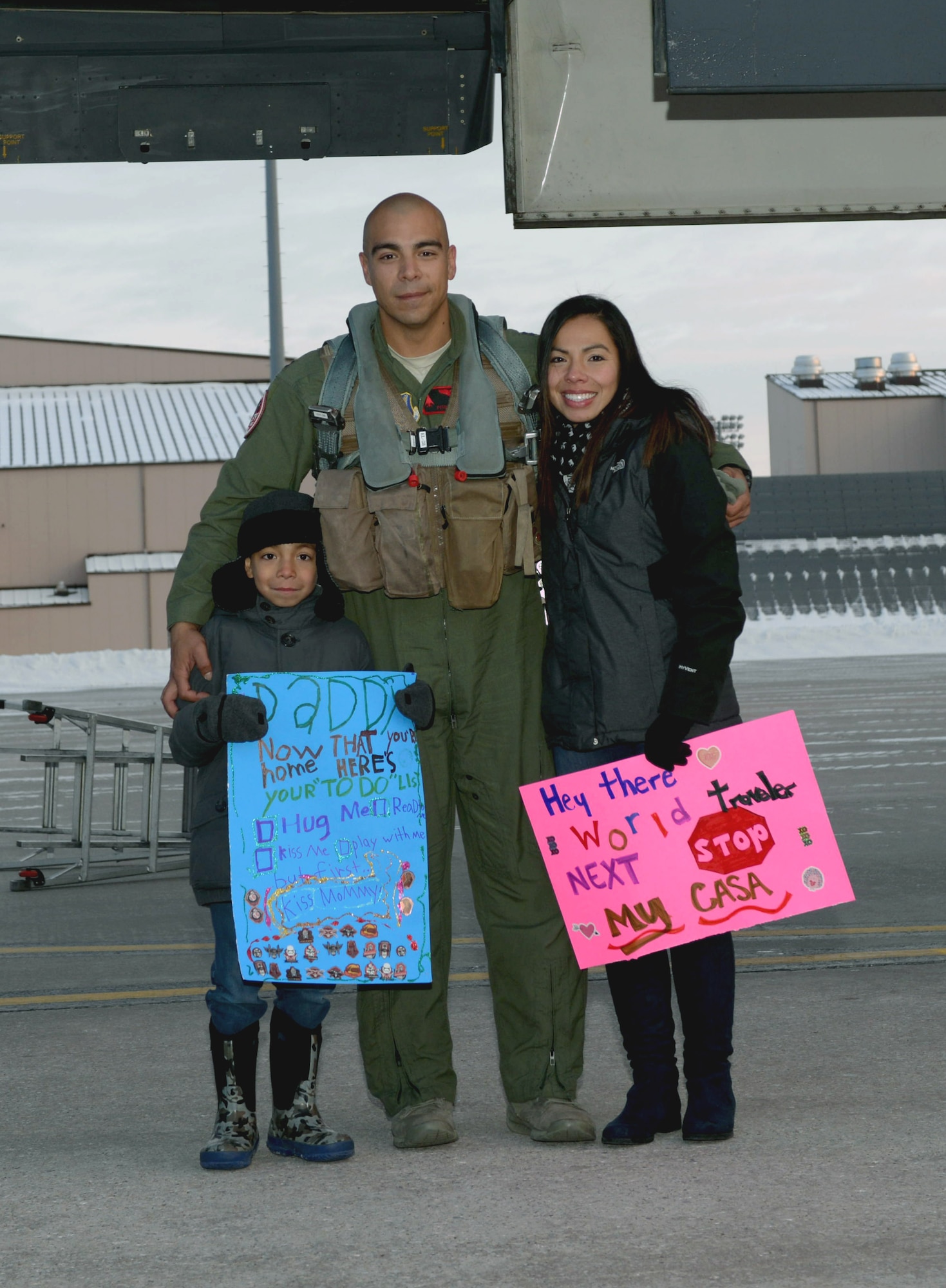 Capt. Sam, a pilot assigned to the 34th Expeditionary Bomb Squadron, reunites with his wife, Cindy, and his son, Mateo, at Ellsworth Air Force Base, S.D., Feb. 8, 2017. Ellsworth Airmen conducted integrated bomber training missions in the maritime domain demonstrating our commitment to deterrence, offering assurance to our allies, and strengthening regional security and stability in the Indo-Asia-Pacific region. (U.S. Air Force photo by Airman 1st Class Donald C. Knechtel)