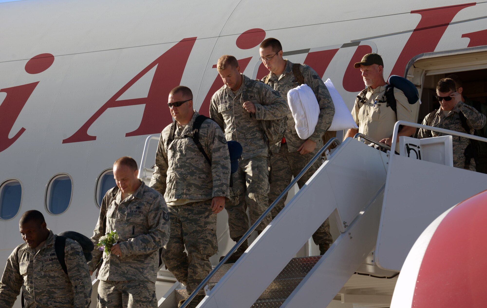 Airmen returning from their deployment step off the plane and are welcomed home at Ellsworth Air Force Base, S.D., Feb. 12, 2017. Ellsworth Airmen conducted integrated bomber training and missions in the maritime domain demonstrating our commitment to deterrence, offering assurance to our allies, and strengthening regional security and stability in the Indo-Asia-Pacific region. (U.S. Air Force photo by Airman 1st Class Donald C. Knechtel)