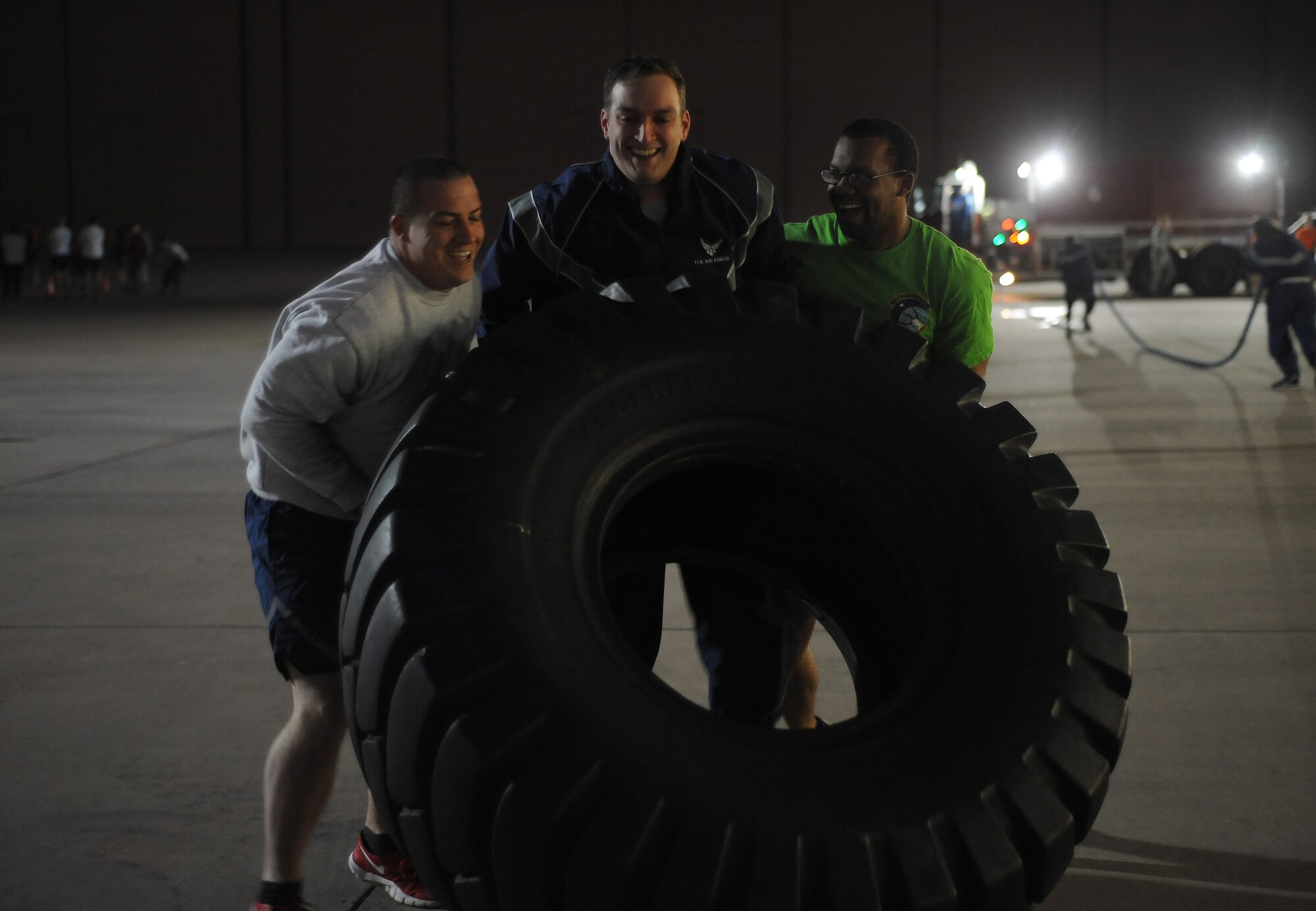 Airmen assigned to the 7th Civil Engineer Squadron and the 7th Communications Squadron take part in tire flipping during the Ray Rangel Remembrance Muster, Feb. 13, 2017, at Dyess Air Force Base, Texas. Dyess Airmen participated in a firefighter-geared workout to challenge the physical strength and endurance that is used during an emergency. (U.S. Air Force photo by Airman 1st Class Emily Copeland)