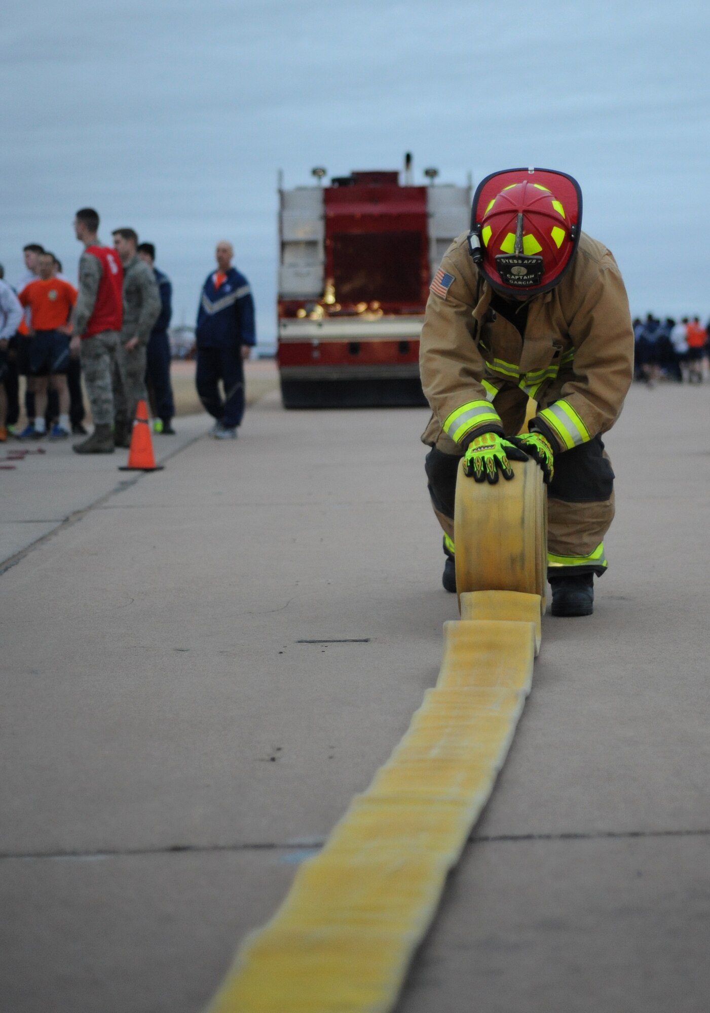 Martin Garcia, the 7th Civil Engineer Squadron lead firefighter, rolls up a fire hose during the Ray Rangel Remembrance Muster Feb. 13, 2017, at Dyess Air Force Base, Texas. Dyess Airmen participated in a firefighter geared workout to challenge the physical strength and endurance that is used during an emergency. (U.S. Air Force photo by Airman 1st Class Emily Copeland)