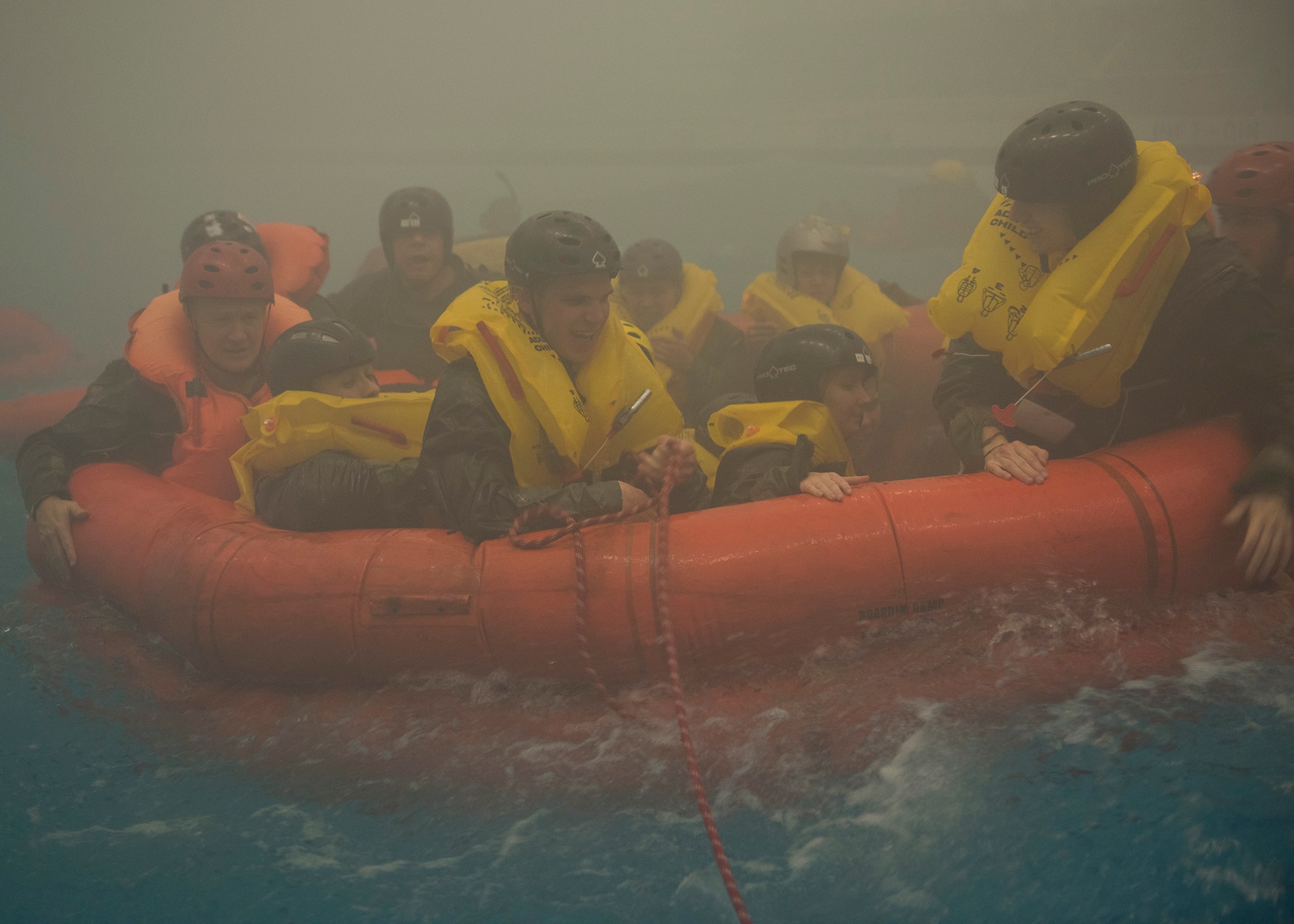 NASA astronauts and Survival School students work to maneuver their life raft against simulated waves during a training session Feb. 10, 2017, at Fairchild Air Force Base, Wash. Survival School students are given experiences as close to real life emergency situations as possible. (U.S. Air Force photo/ Airman 1st Class Ryan Lackey)