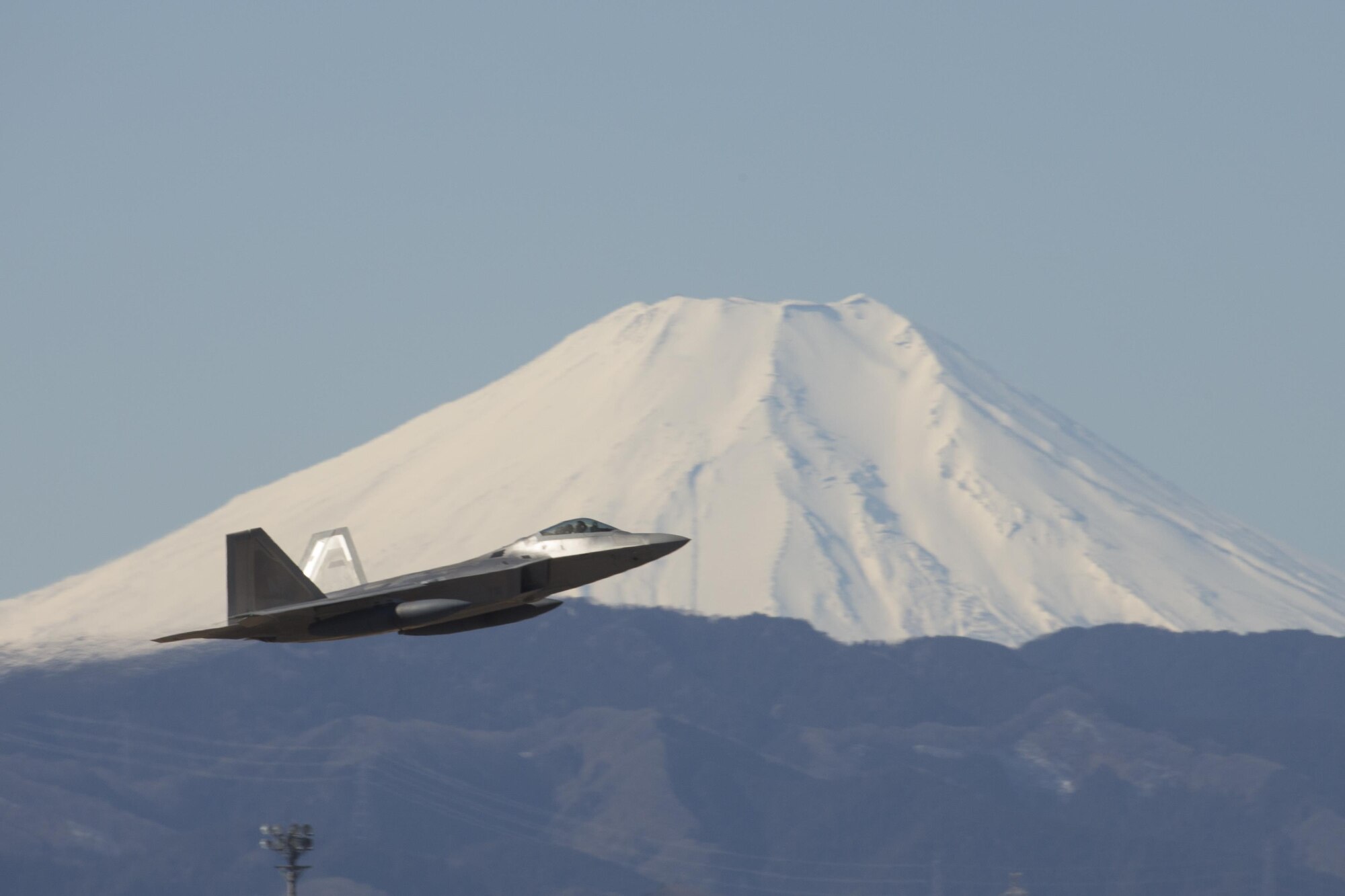 A U.S. Air Force F-22 Raptor from the 90th Fighter Squadron at Joint Base Elmendorf-Richardson, takes off at Yokota Air Base, Japan, Feb. 13, 2017. The F-22 Raptors stopped at Yokota AB before traveling on to Royal Australian Air Force Base, Tindal. As the Air Force’s Western Pacific airlift hub, Yokota supports transient aircraft as they conduct mission throughout the Indo-Asia Pacific Region. (U.S. Air Force photo by Yasuo Osakabe/Released)