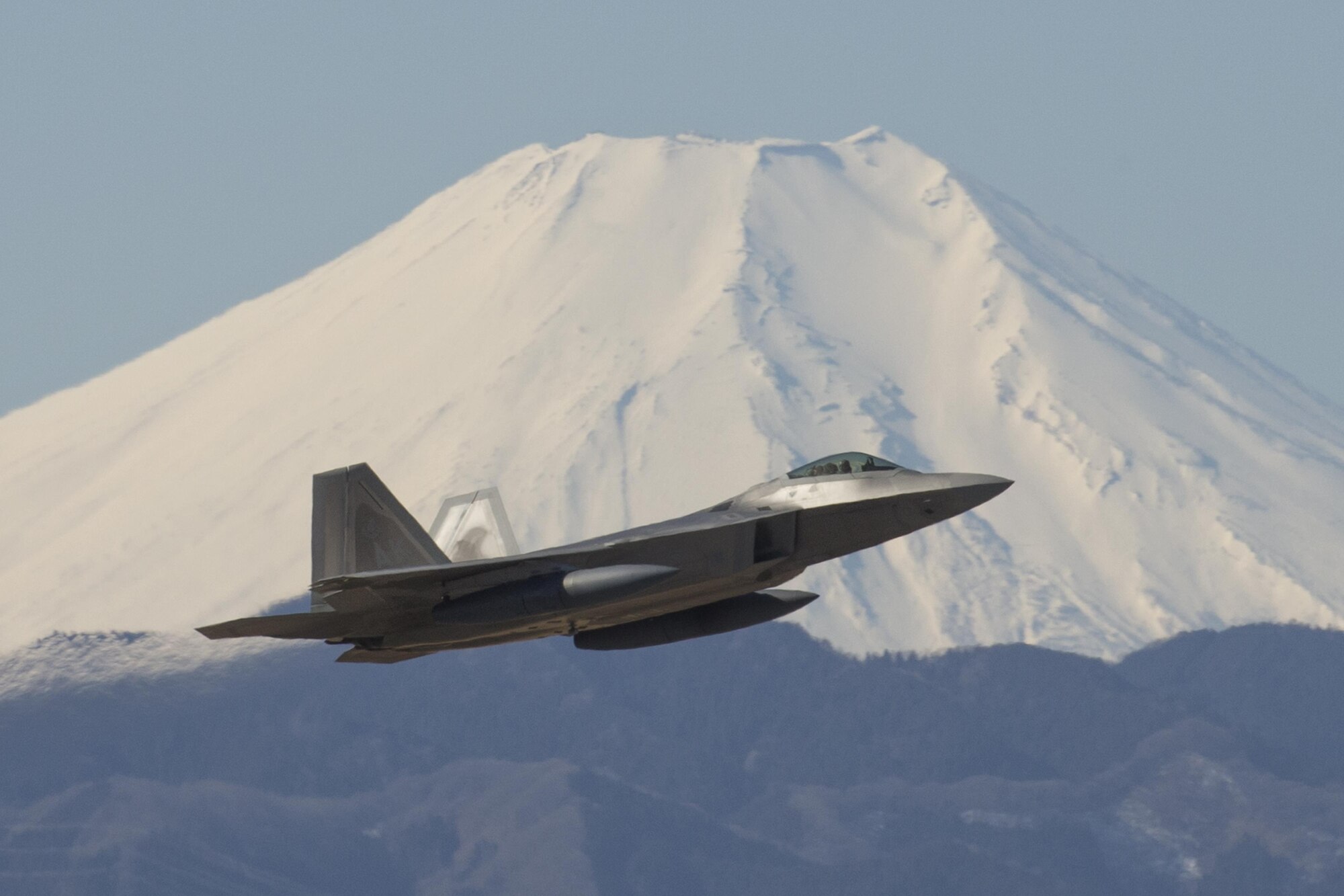 A U.S. Air Force F-22 Raptor from the 90th Fighter Squadron at Joint Base Elmendorf-Richardson, takes off at Yokota Air Base, Japan, Feb. 13, 2017. The F-22 Raptors stopped at Yokota AB before traveling on to Royal Australian Air Force Base, Tindal. As the Air Force’s Western Pacific airlift hub, Yokota supports transient aircraft as they conduct mission throughout the Indo-Asia Pacific Region. (U.S. Air Force photo by Yasuo Osakabe/Released)