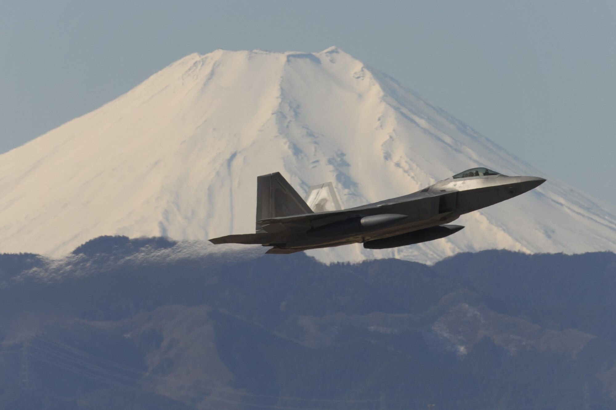 A U.S. Air Force F-22 Raptor from the 90th Fighter Squadron at Joint Base Elmendorf-Richardson, takes off at Yokota Air Base, Japan, Feb. 13, 2017. The F-22 Raptors stopped at Yokota AB before traveling on to Royal Australian Air Force Base, Tindal. As the Air Force’s Western Pacific airlift hub, Yokota supports transient aircraft as they conduct mission throughout the Indo-Asia Pacific Region. (U.S. Air Force photo by Yasuo Osakabe/Released)