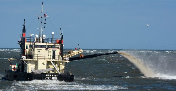 The shallowdraft, sidecast vessel MERRITT dredges the federal channel at Oregon Inlet.