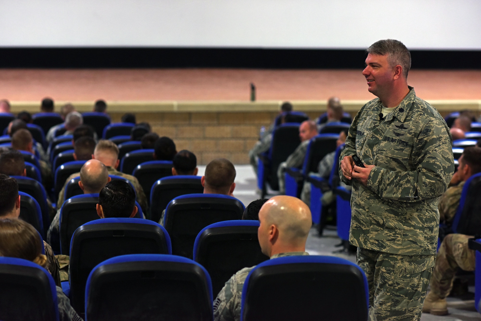 U.S. Air Force Lt. Col. George Sanderlin, senior professionalism instructor for the Profession of Arms Center of Excellence course, speaks to a theater full of Airmen at Al Udeid Air Base, Qatar, Feb. 10, 2017. The Airmen attended the first PACE course taught in the U.S. Central Command area of responsibility. (U.S. Air Force photo by Senior Airman Cynthia A. Innocenti)