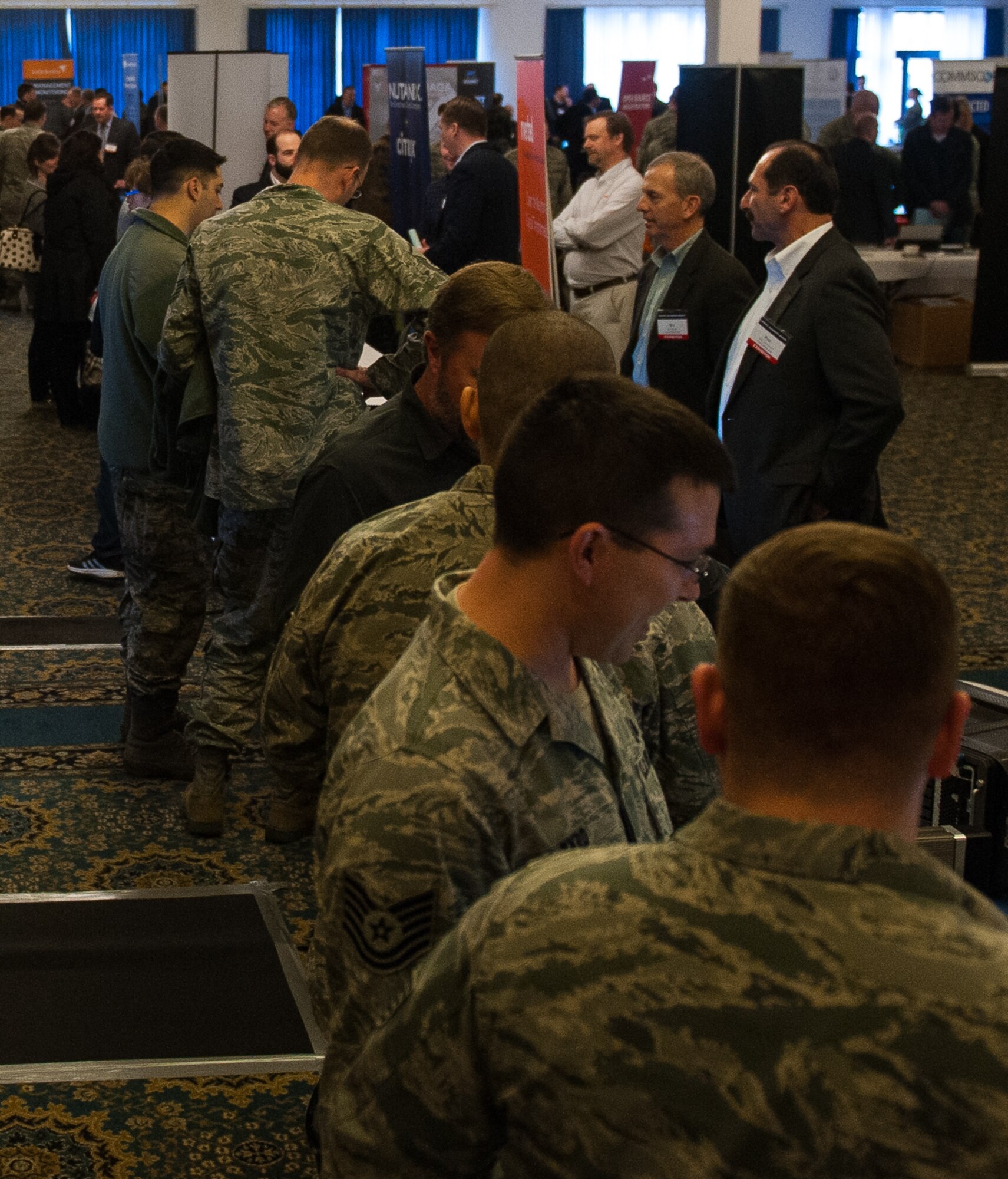 People attend the 2017 Winter Ramstien Tech Expo at Ramstein Air Base, Germany, Feb. 8, 2017. The event was put on by the Armed Forces Communications and Electronics Association, a non-profit international organization which seeks to develop networks between people involved in science, technology, engineering and mathematics by creating a medium for the ethical exchange of information. (U.S. Air Force photo by Senior Airman Lane T. Plummer)