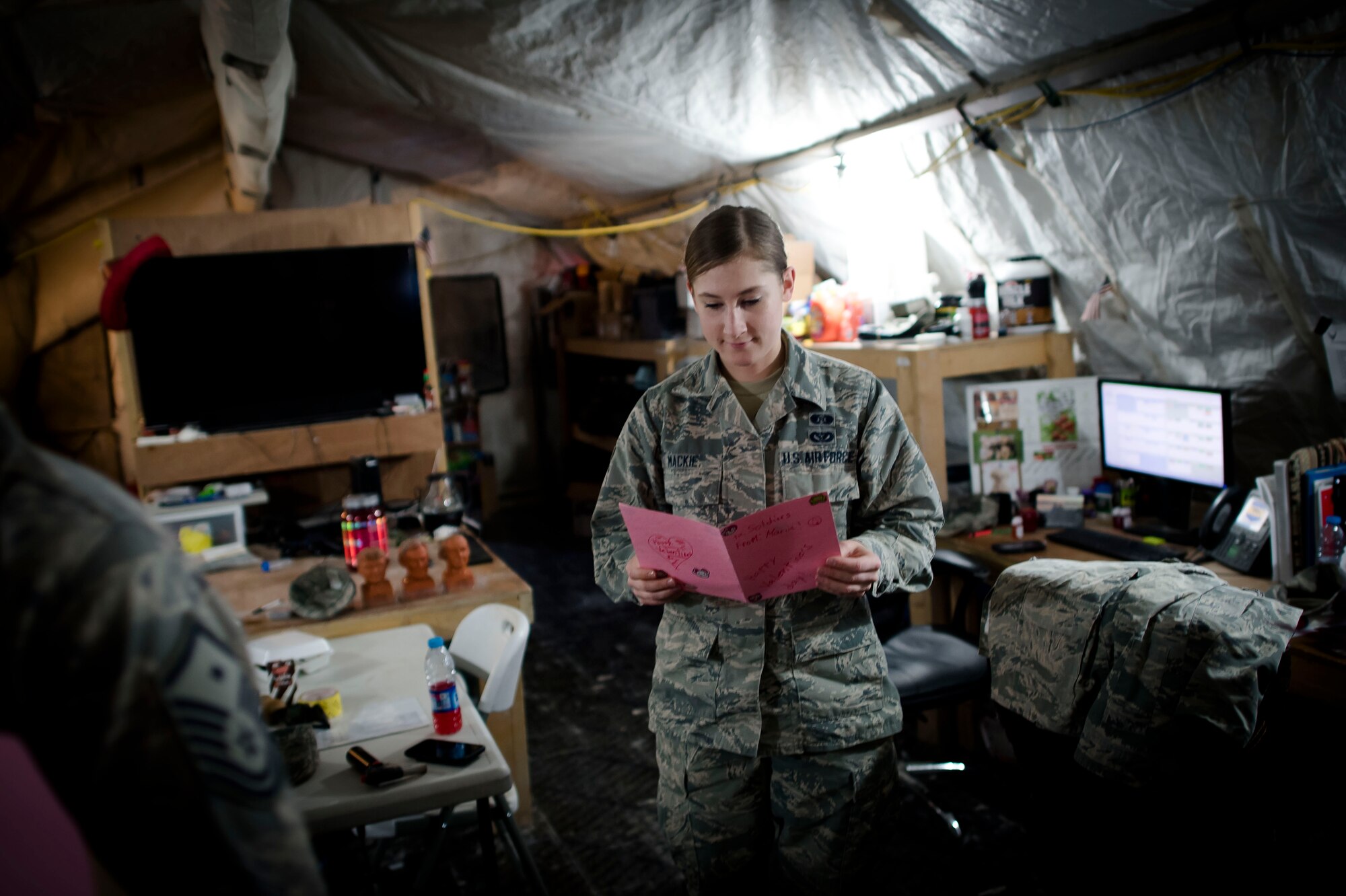 Airman 1st Class Meagan Mackie, 332nd Expeditionary Civil Engineer Squadron emergency management journeyman, reads a Valentine’s Day card, Feb. 14, 2017, in Southwest Asia. Students from Cape Cod, Massachusetts handcrafted cards for service members serving overseas. (U.S. Air Force photo by Staff Sgt. Eboni Reams)