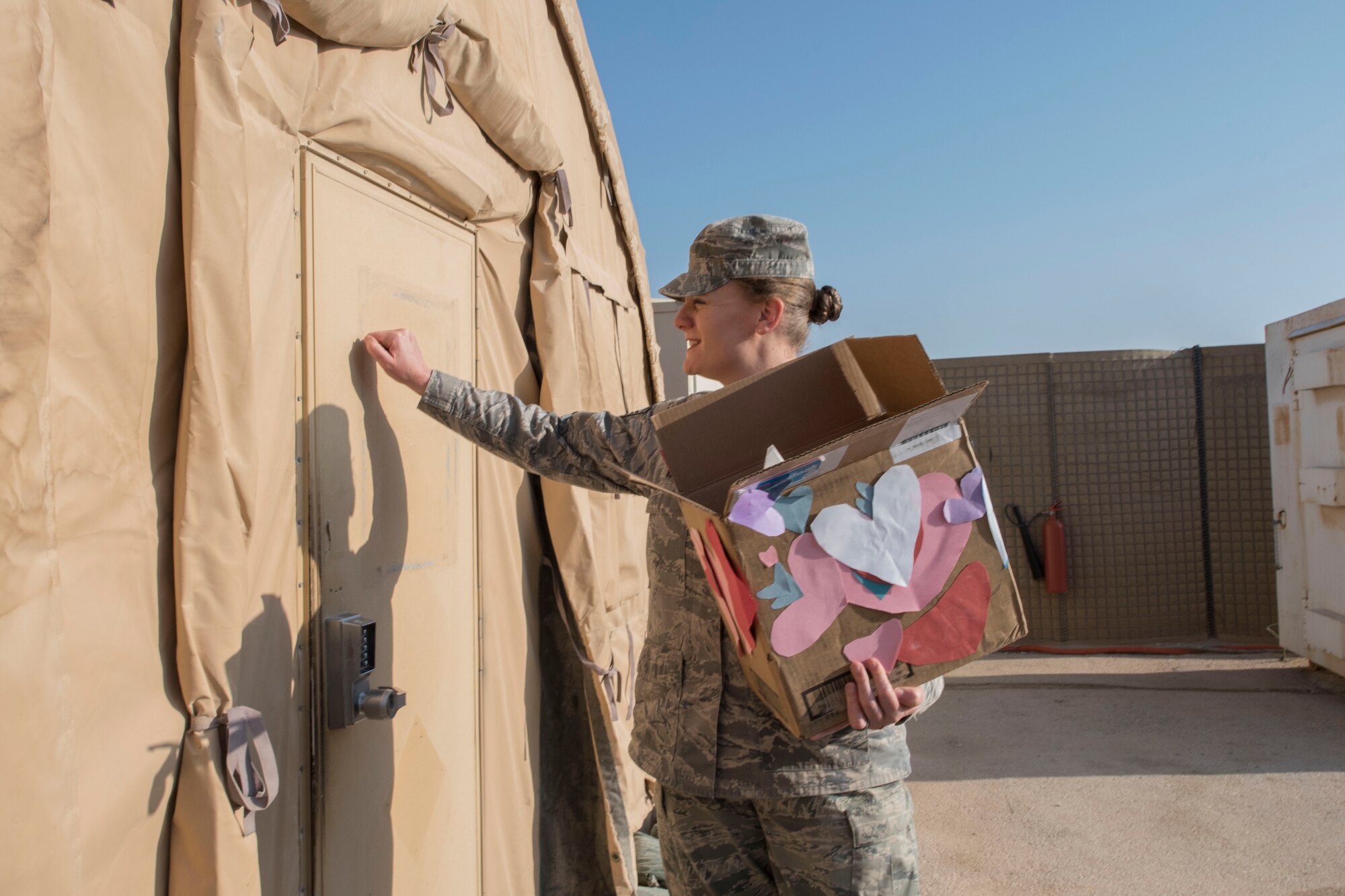 Airman 1st Class Meagan Mackie, 332nd Expeditionary Civil Engineer Squadron emergency management journeyman, reads a Valentine’s Day card, Feb. 14, 2017, in Southwest Asia. Students from Cape Cod, Massachusetts handcrafted cards for service members serving overseas. (U.S. Air Force photo by Staff Sgt. Eboni Reams)