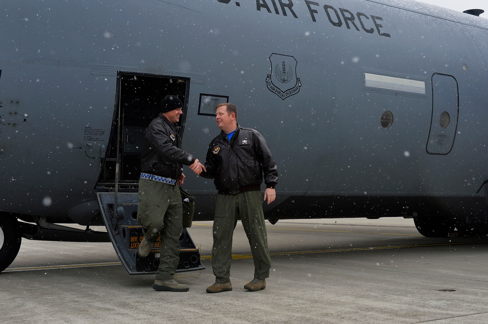 Lt. Col. Barry A. King. II, 37th Airlift Squadron commander, left, shakes hands with Chief Master Sgt. Samuel Frederick, 37th AS superintendent, as he disembarks a C-130J Super Hercules on Ramstein Air Base, Germany, Feb. 10, 2017. The 37th AS celebrated its 75th Anniversary with a training mission which culminated with a flight over the squadron building. (U.S. Air Force photo by Airman 1st Class Joshua Magbanua)