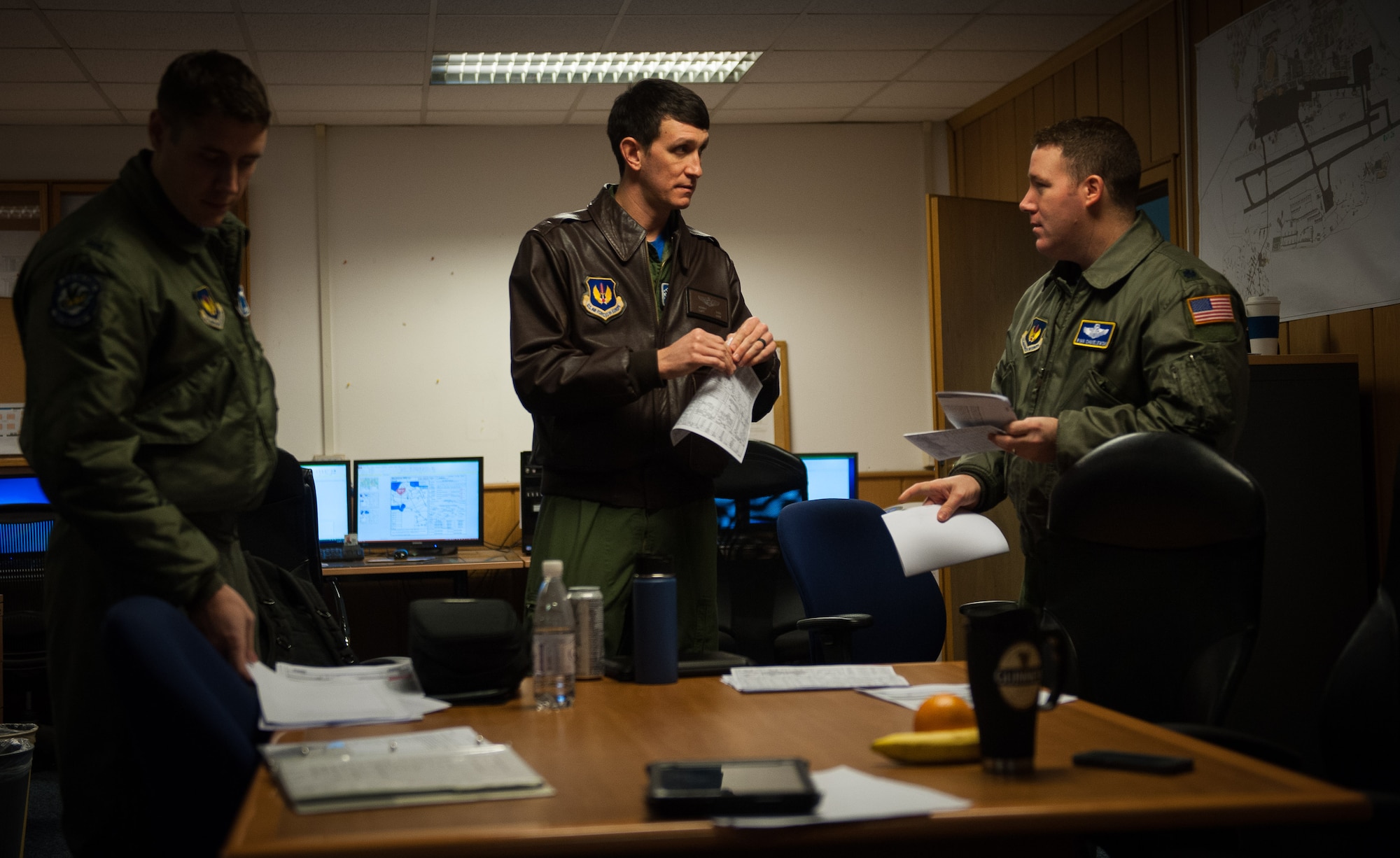 Lt. Col. Ryan Chmielewski, 37th Airlift Squadron director of operations, coordinates with Capt. Kenneth Jubb, 37th AS pilot, on their unit’s 75th anniversary flight at Ramstein Air Base, Germany, Feb. 10, 2017. 37th AS pilots took to the skies to honor all those before them who have worn the unit patch. (U.S. Air Force photo by Senior Airman Lane T. Plummer)