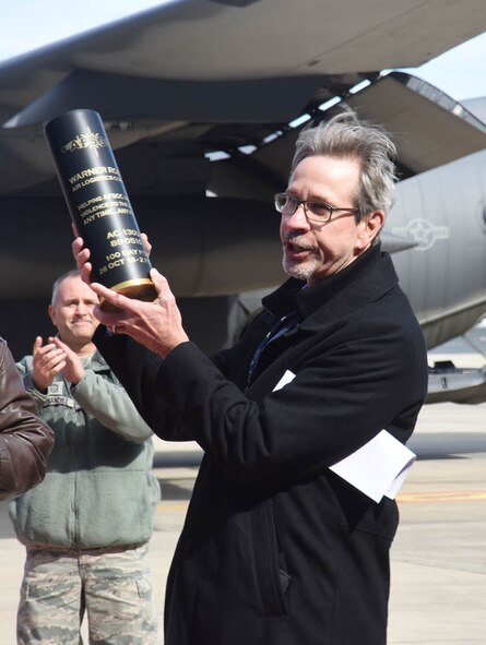 Doug Keene, WR-ALC  special assistant to the commander, holds up a 105mm round presented to the Warner Robins Air Logistics Complex from Maj. Gen. Haase on behalf of the 19,000 men and women who make up Air Force Special Operations Command. Haase was here to thank the workforce for the expedited work done on Special Ops aircraft over the course of the last year. (U.S. Air Force photo by Ed Aspera) 