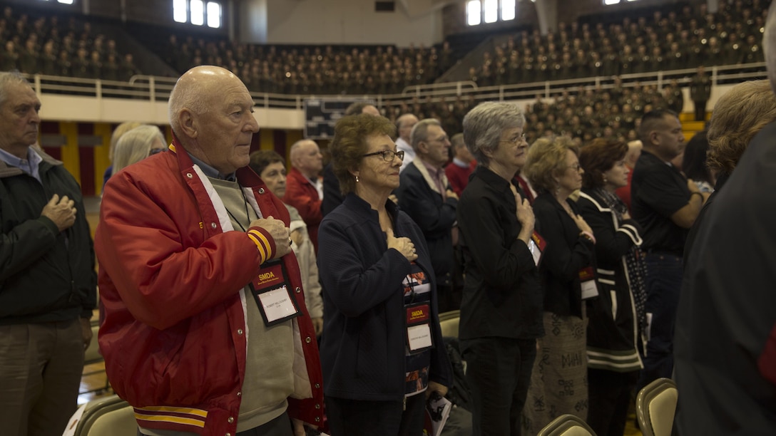 Marine veterans and their families salute the 2nd Marine Division’s colors at a battle colors rededication ceremony for 2nd MarDiv at Camp Lejeune, N.C., Feb. 10, 2017. The ceremony consisted of veterans, who severed in different eras of American Conflict, awarding streamers to the division’s colors for maintaining the legacy passed down from generation to generation. The event coincides with the 76th  birthday of the division.